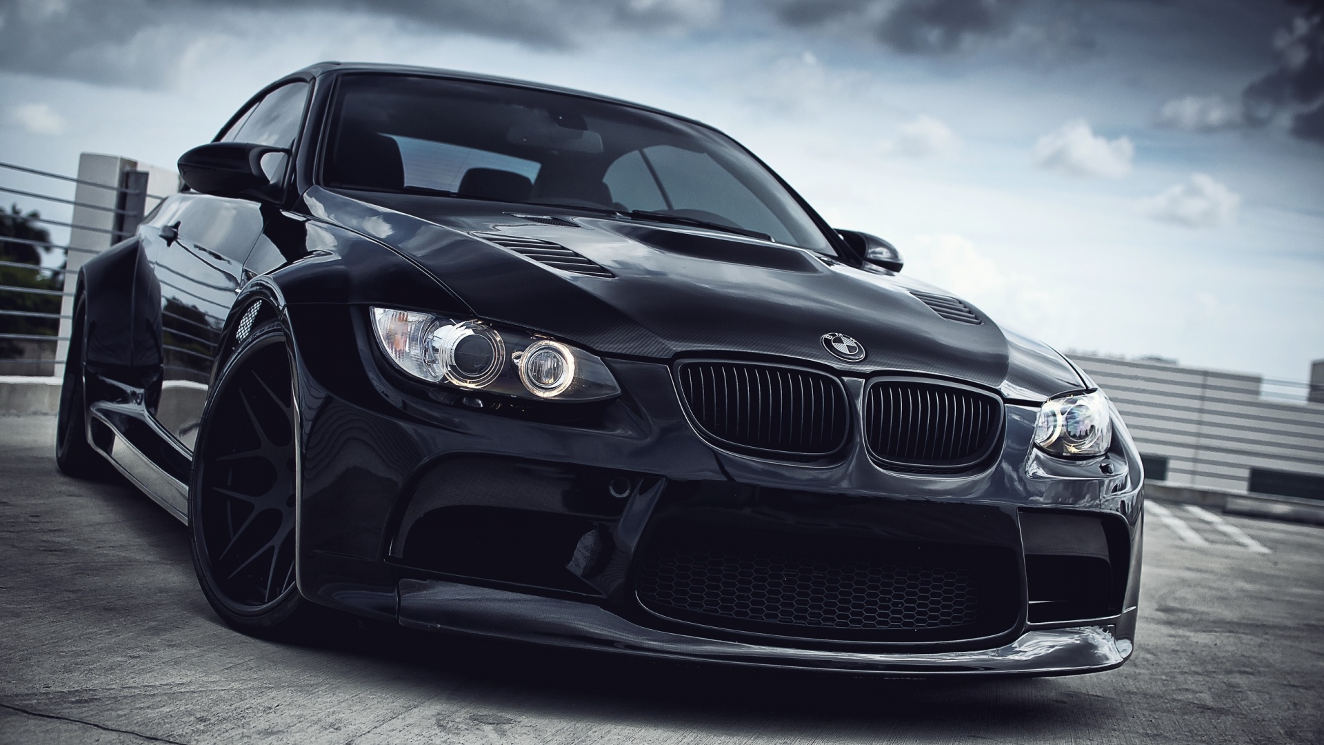 Sleek Black Tuned BMW M3 Coupe Parked on Rooftop