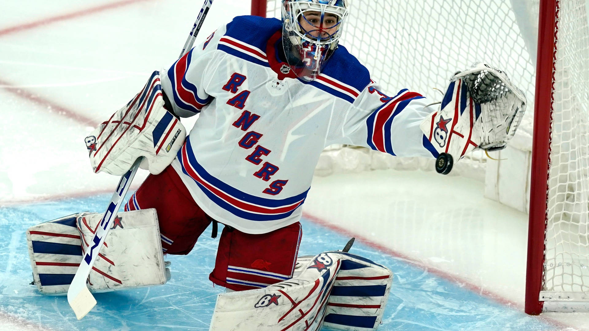 New York Rangers goalie makes a save during an ice hockey game