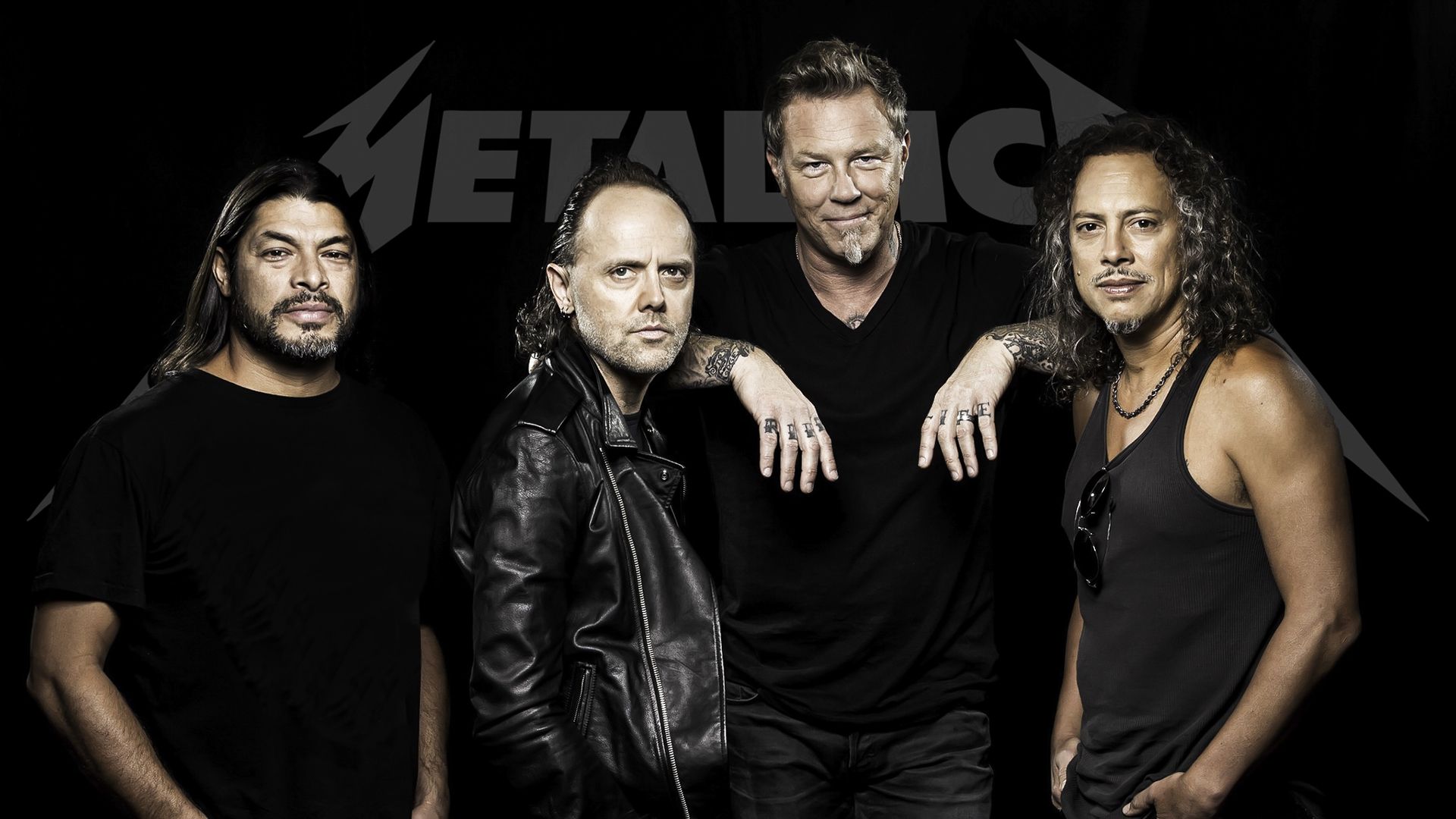 Metallica band members posing against a black background with the band's logo