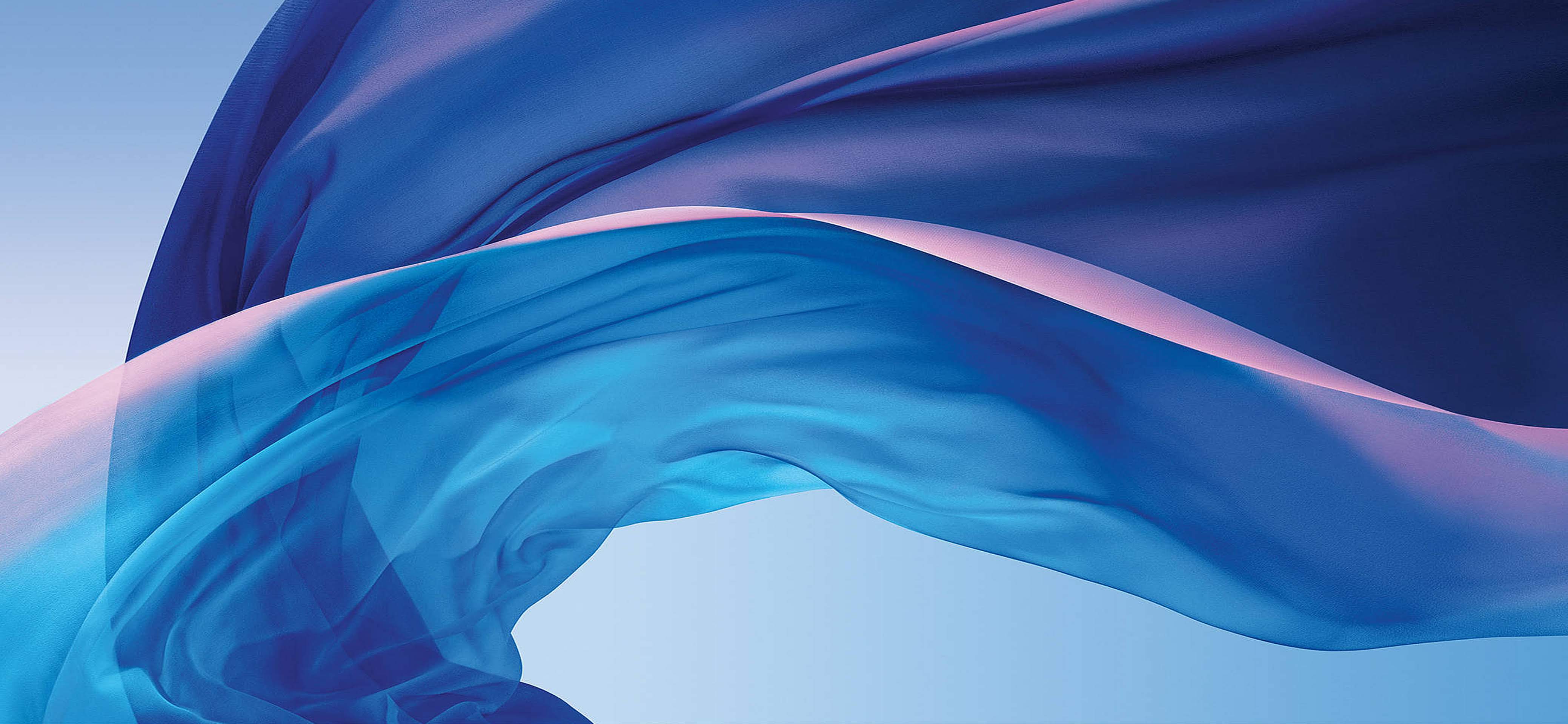 Abstract image of flowing blue and purple fabric, resembling the dynamic wallpapers often found on MacBooks