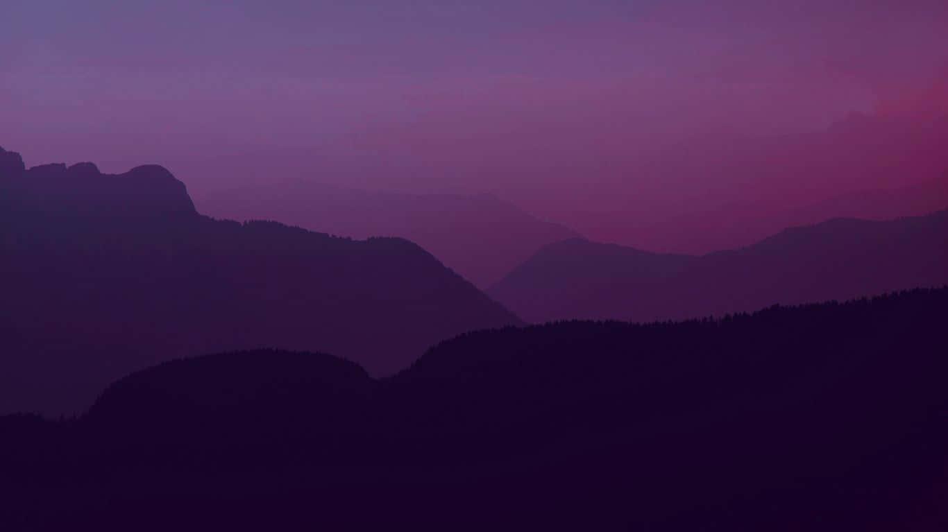 A Purple Sky With Mountains Wallpaper