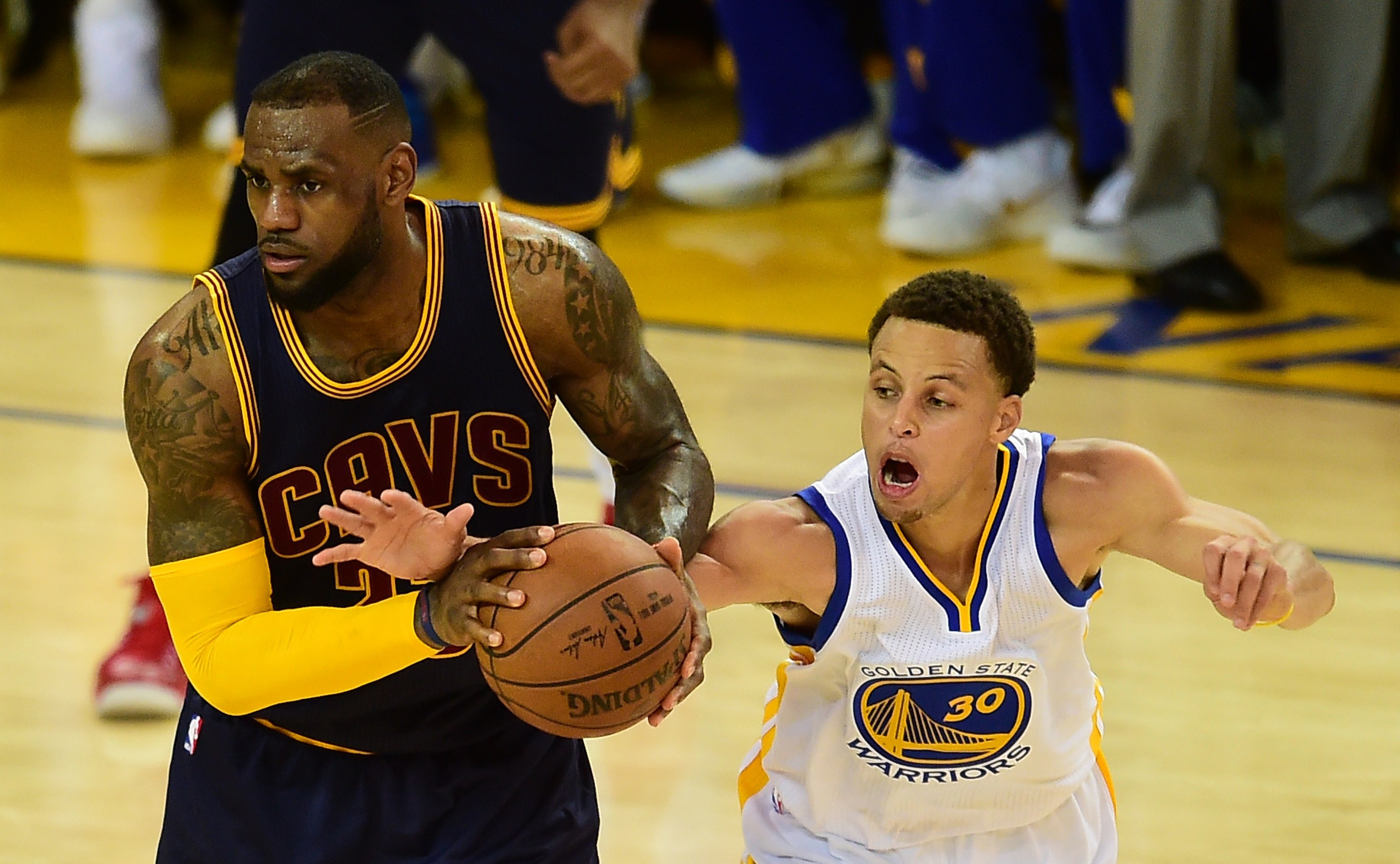 LeBron James and Stephen Curry battling for the ball during an NBA game