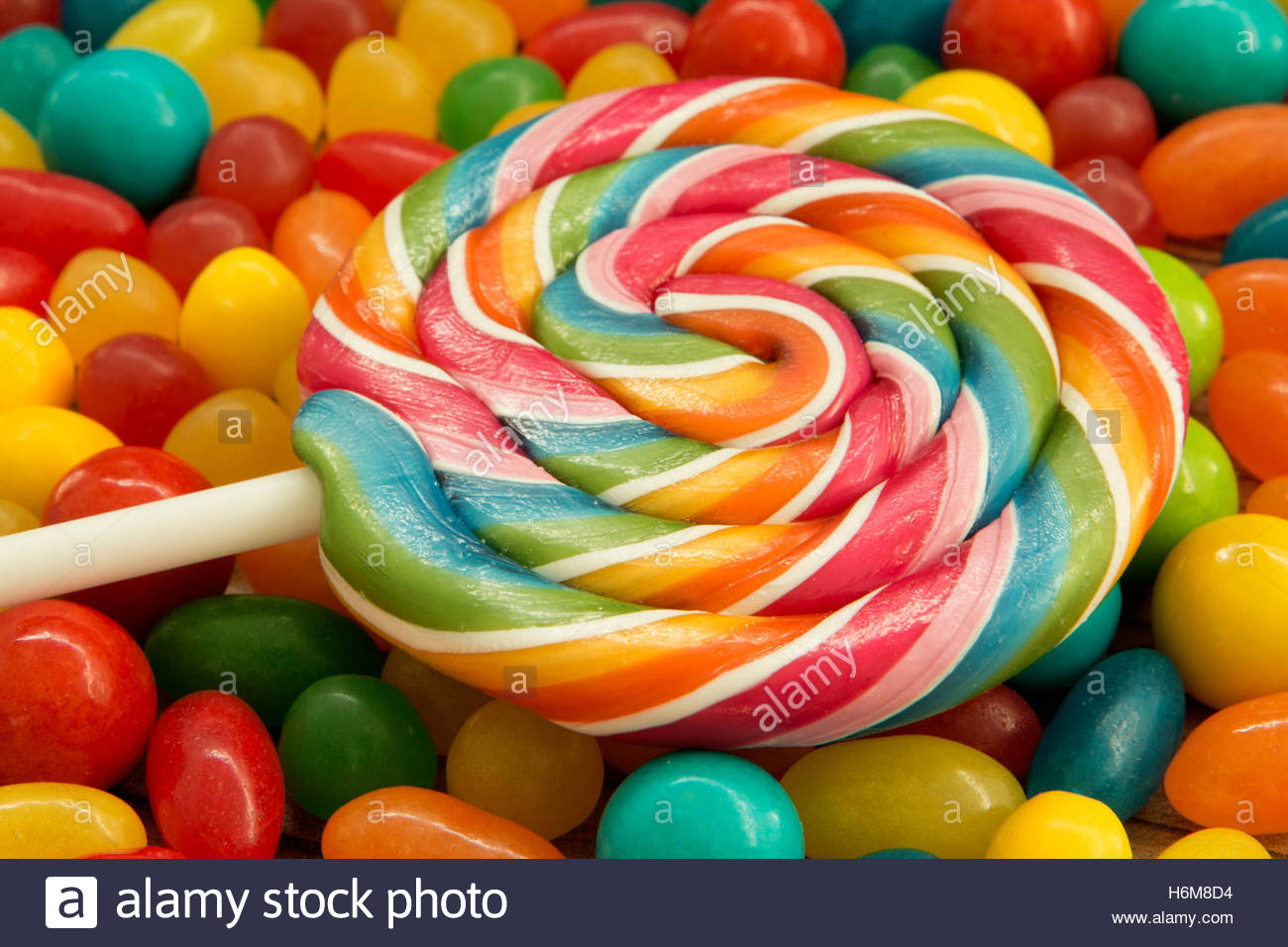 Colorful Jelly Beans And Lollipop Close To Wallpaper Stock Photo