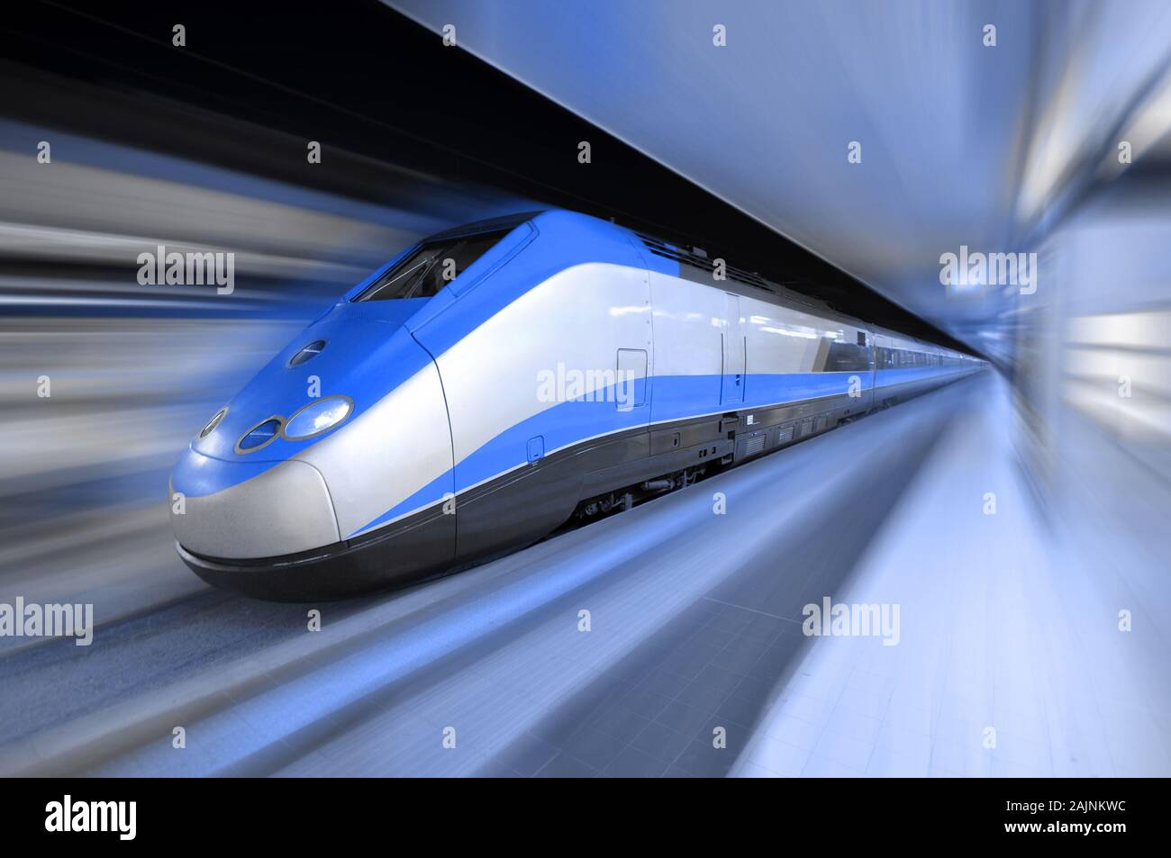 Fast Train Traveling At High Speed Through A Station Stock Photo