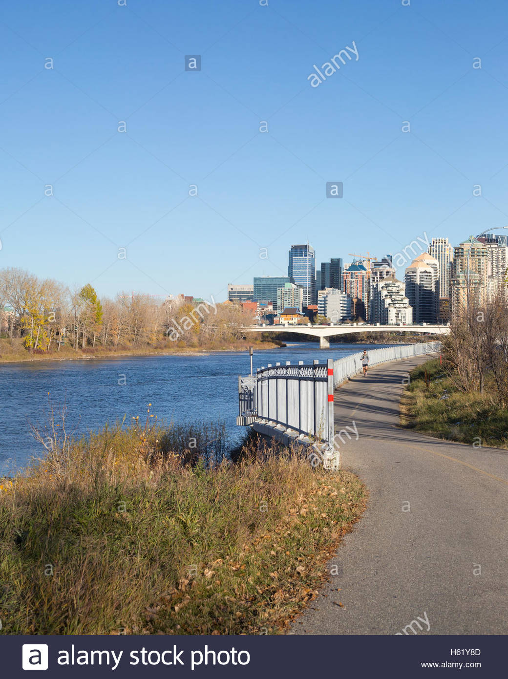 Bow River pathway with downtown Calgary in background Stock Photo