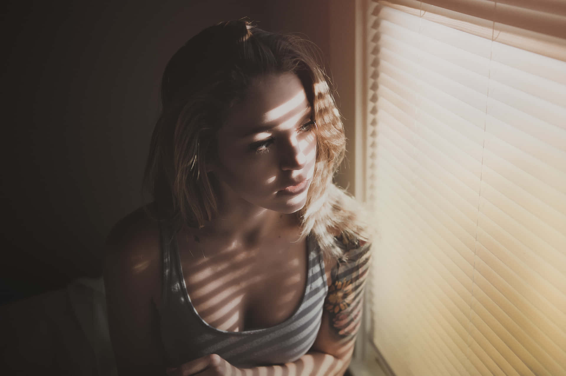 Mujer Soltera Looking Outside The Window Wallpaper