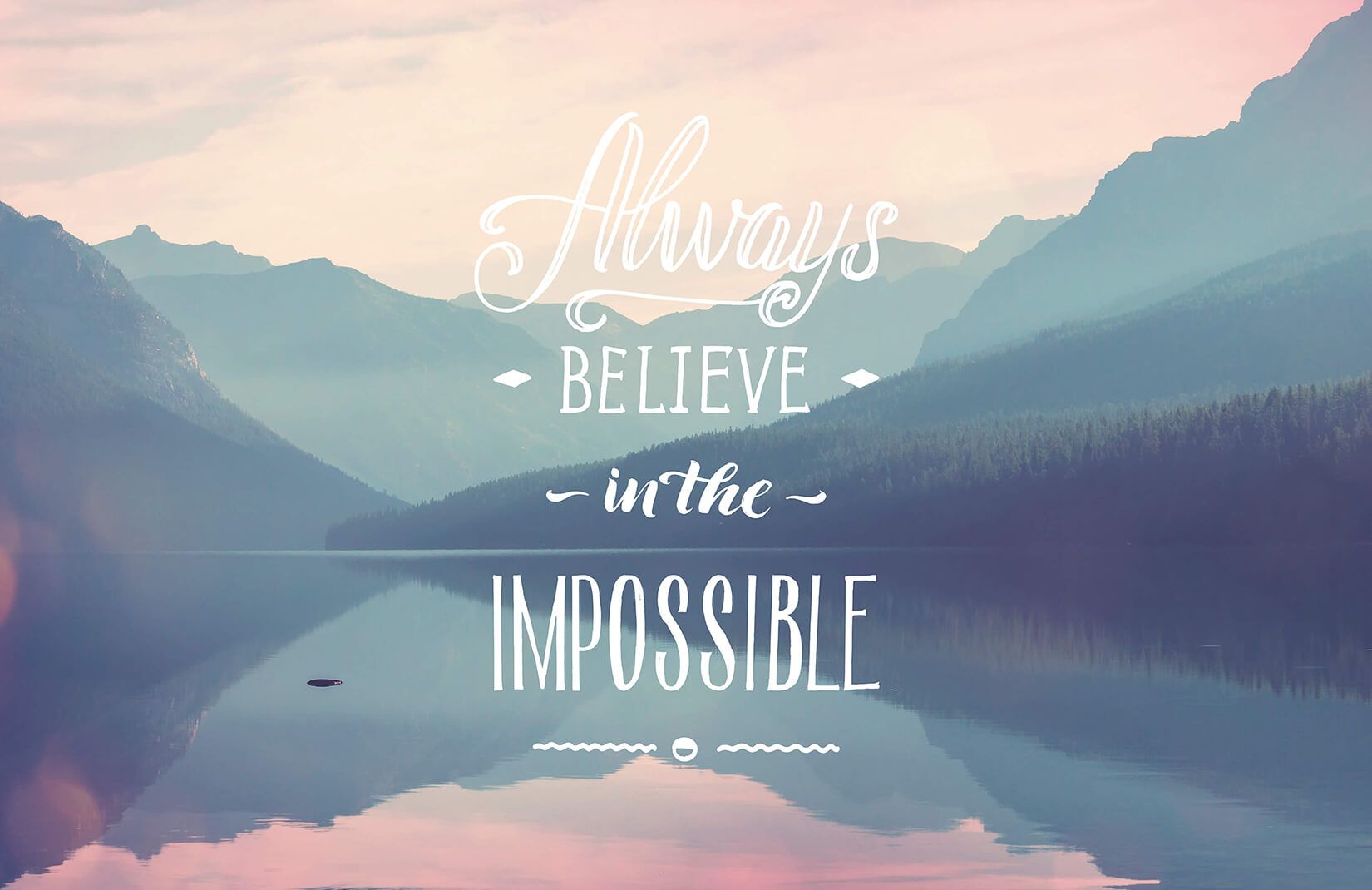 A serene mountain lake reflects the inspiring quote: 