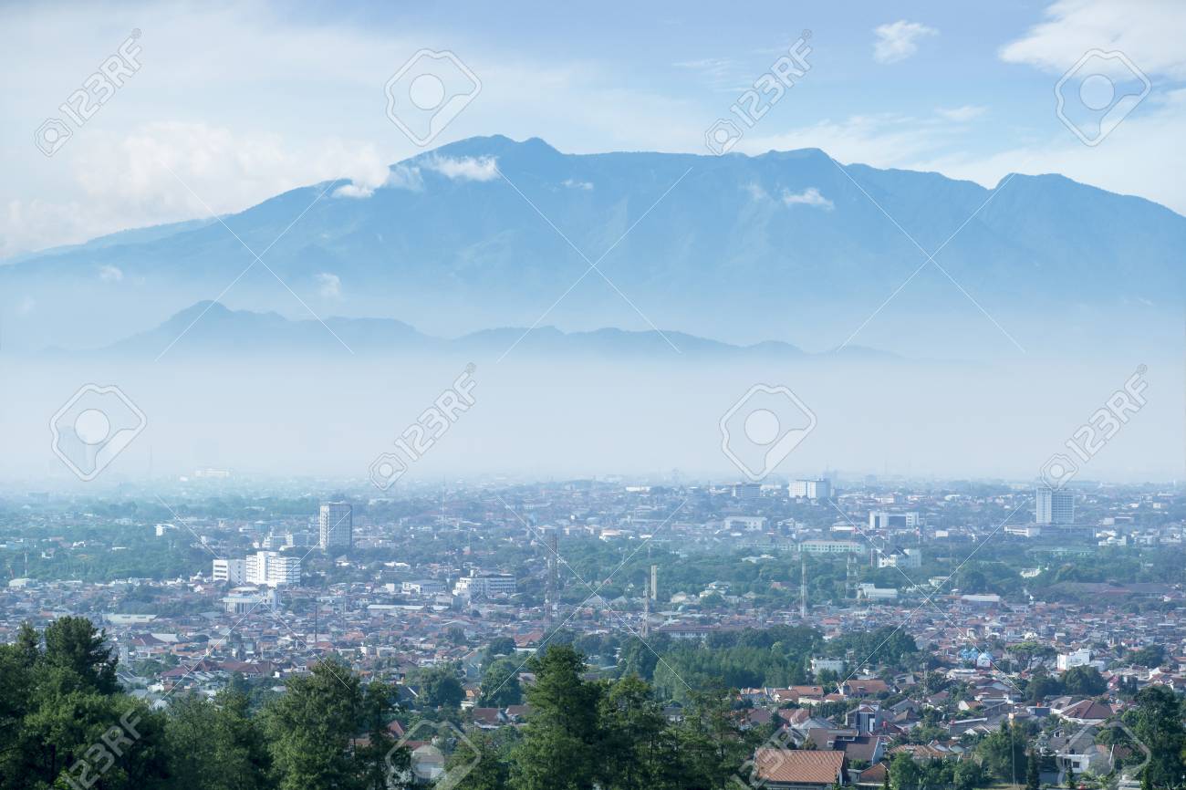 Aerial Of Residential Houses In Misty Mountain Background