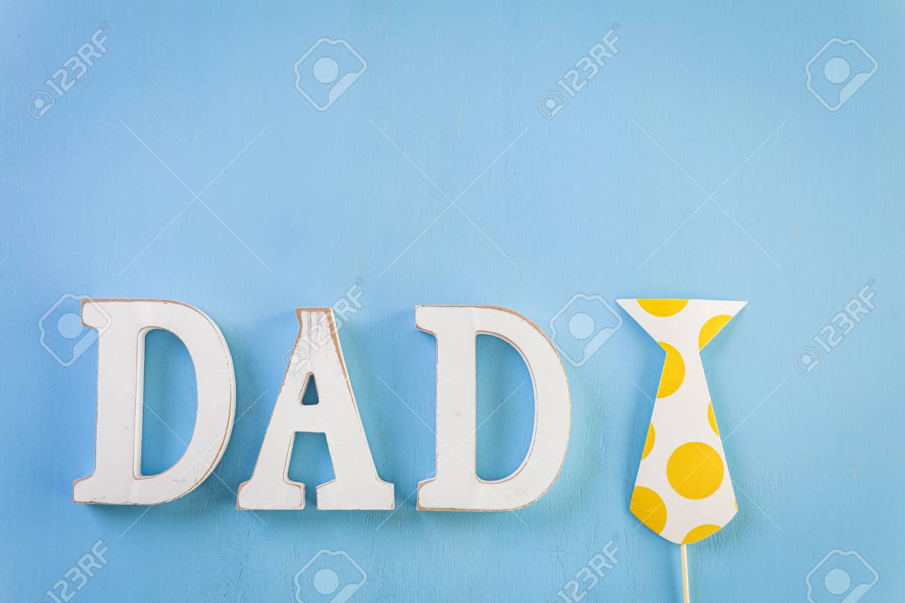 White Letters Dad On A Painted Wood Background Stock Photo