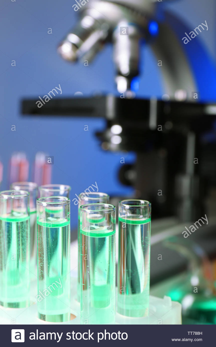 Test Tubes On Microscope Background Stock Photo