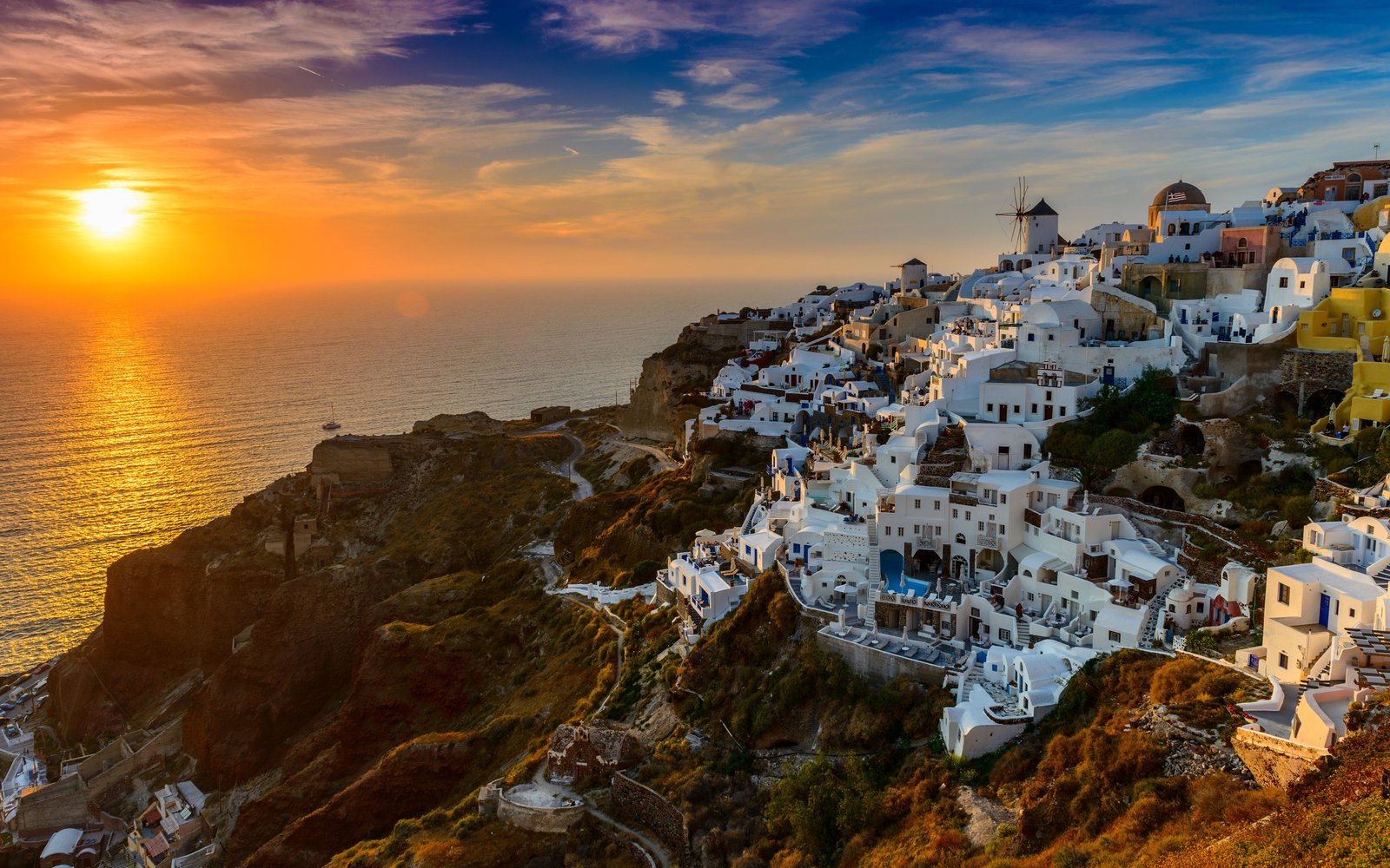 Sunset over the whitewashed buildings of Oia, Santorini, Greece