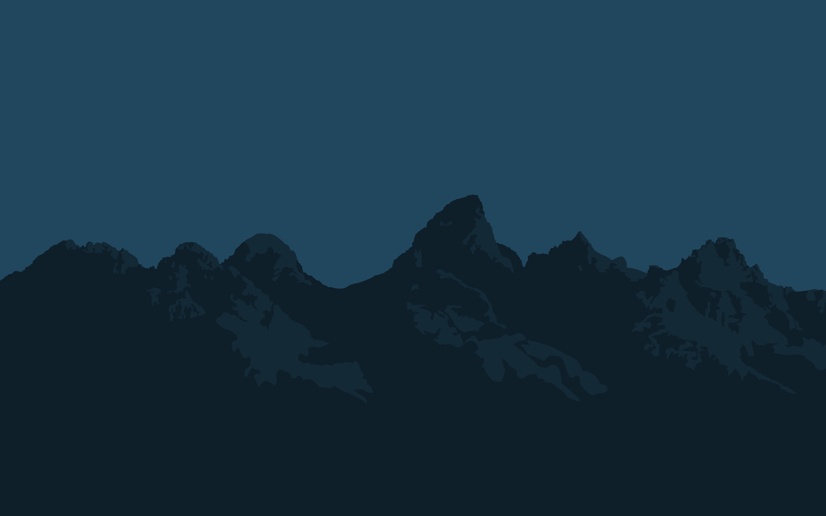 Silhouette of a majestic mountain range against a dusky sky, ideal for a desktop wallpaper