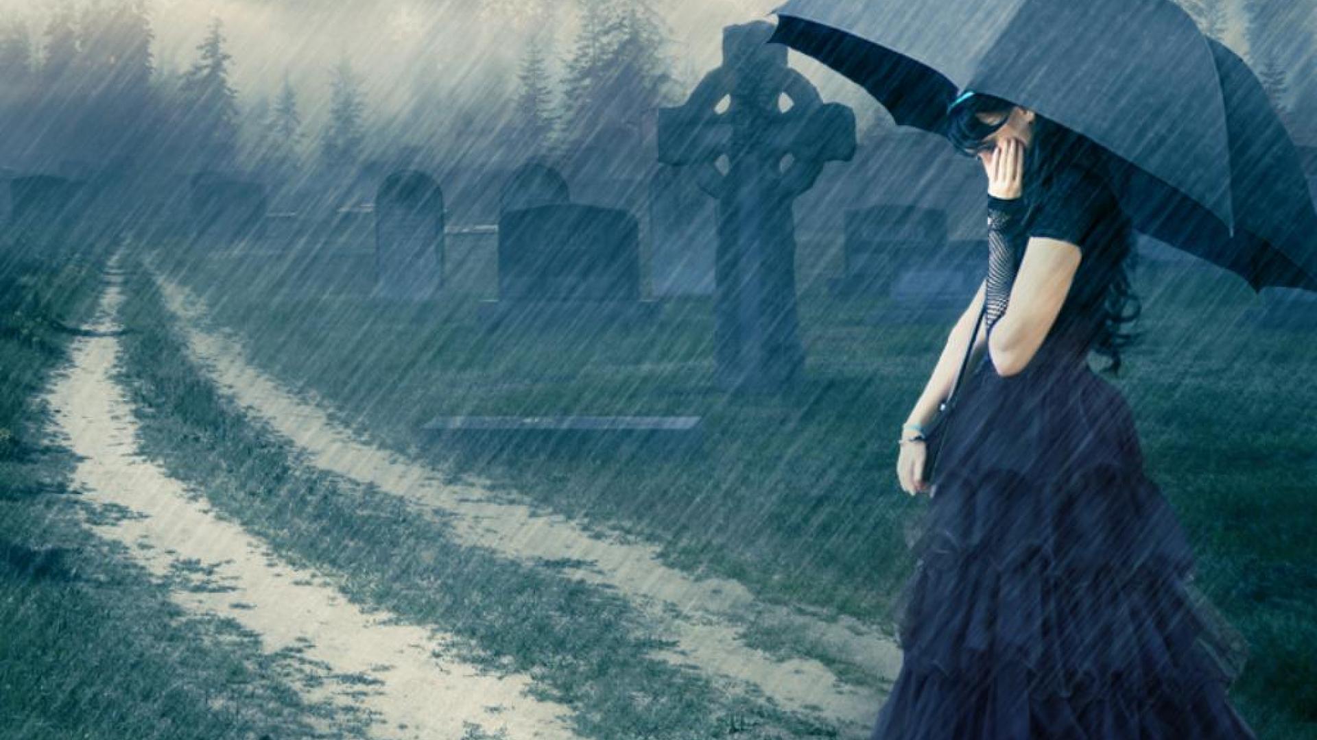 A woman in a black dress stands in a graveyard in the rain, conveying a sense of sadness and loss