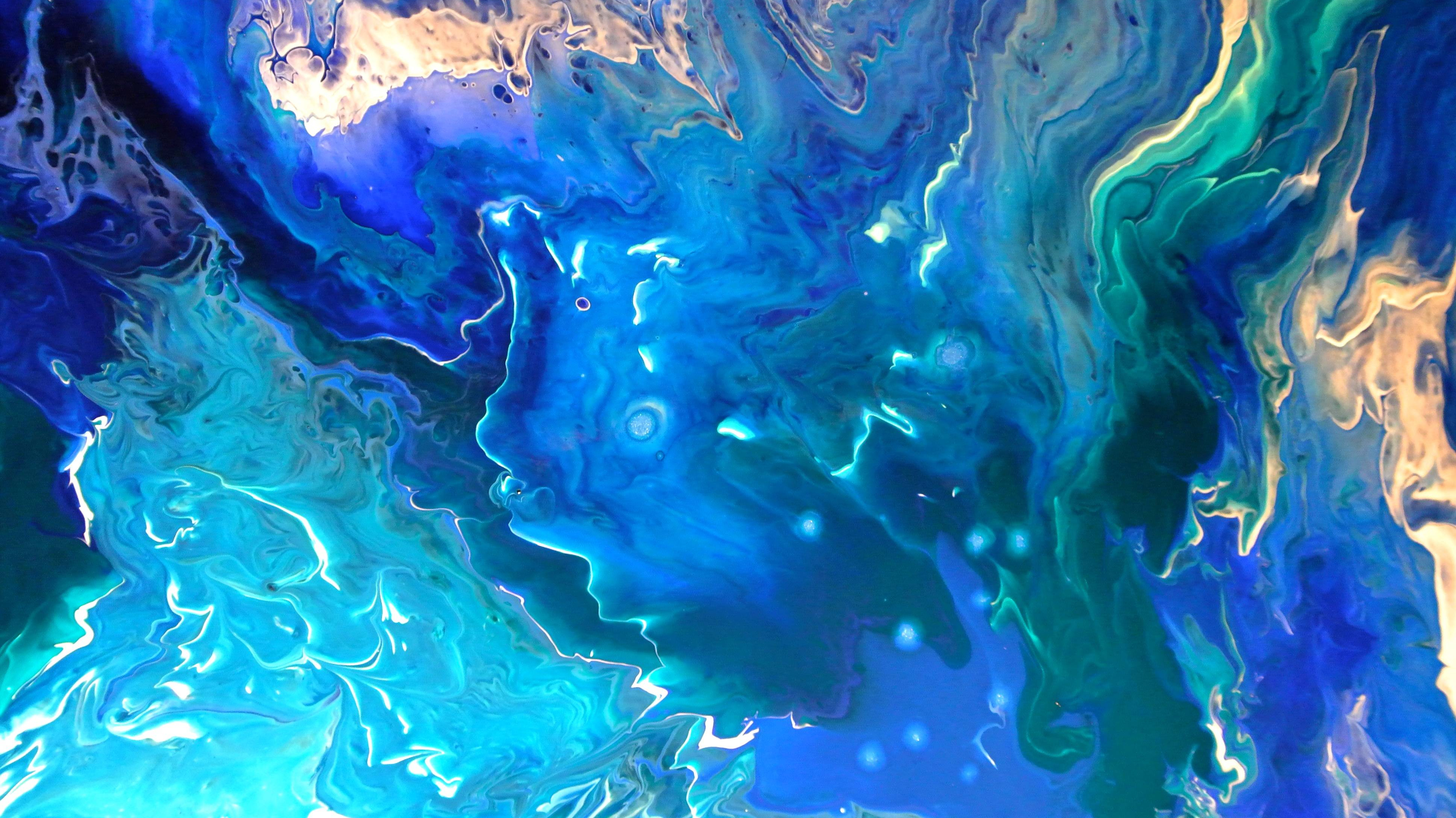 Abstract painting with swirling shades of blue, teal, and gold, resembling a flowing ocean or cosmic scene