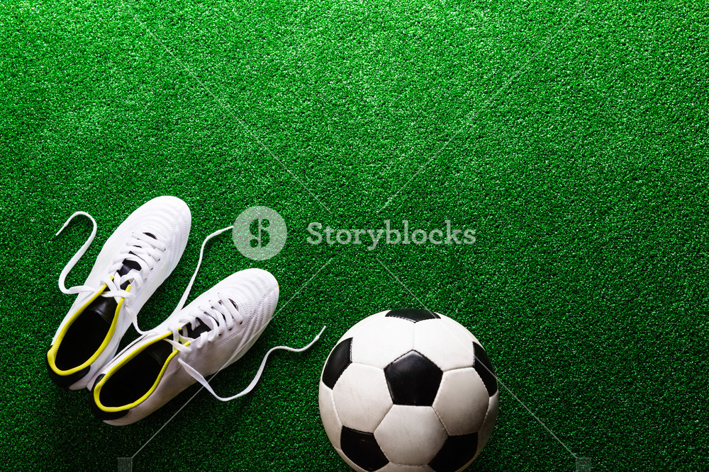 Soccer Ball And Cleats Against Artificial Turf Studio Shot On