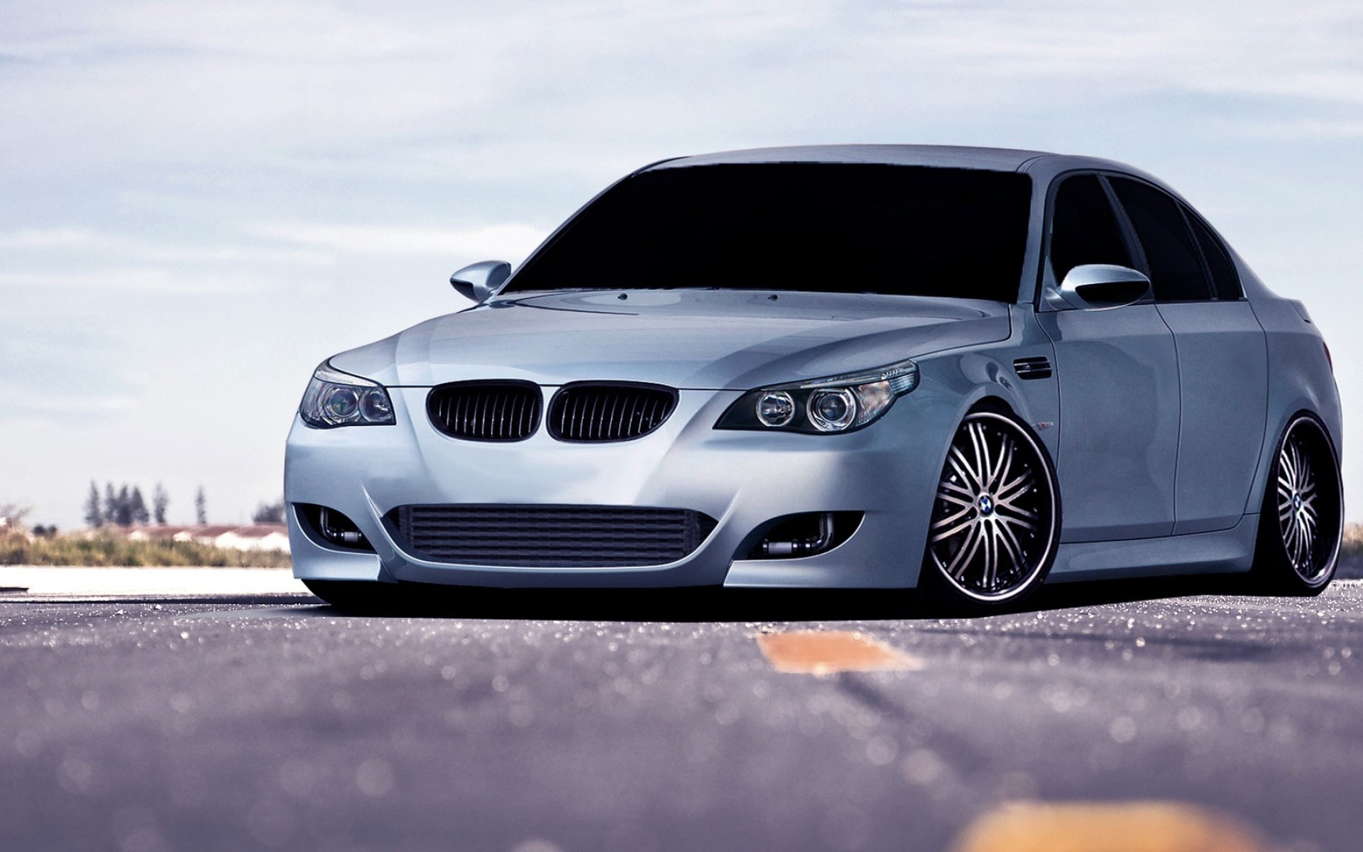 Silver BMW M5 Sedan parked on a paved surface