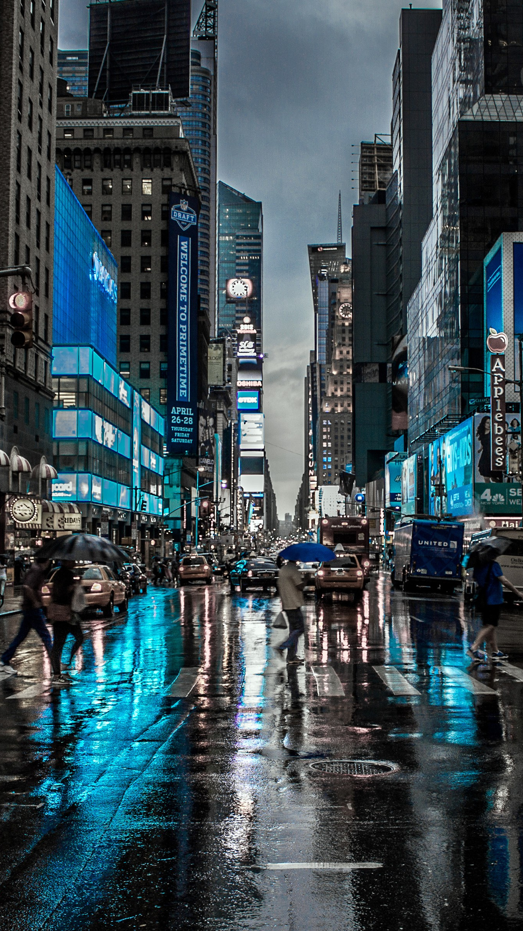 A stunning 4K wallpaper of Times Square in New York City on a rainy night. The vibrant lights of the billboards reflect on the wet streets, creating a captivating urban scene