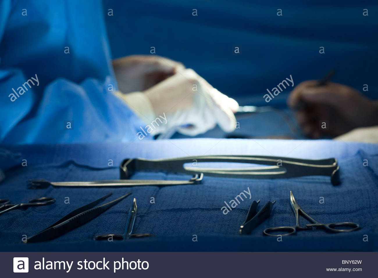 Surgical Instruments Arrayed On Tray Surgeons Operating In Stock