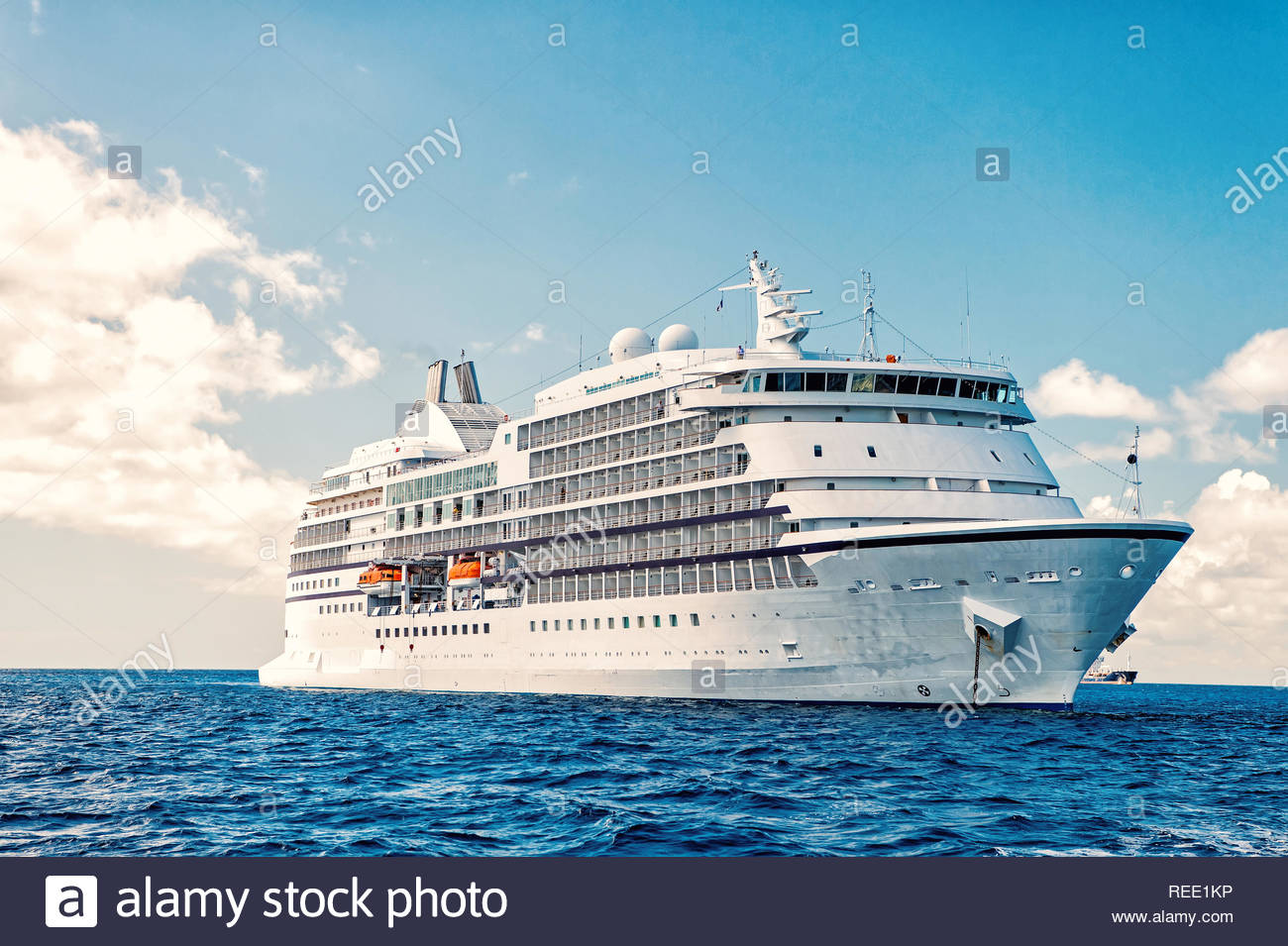 Large Luxury Cruise Ship On Sea Water And Cloudy Sky Background At