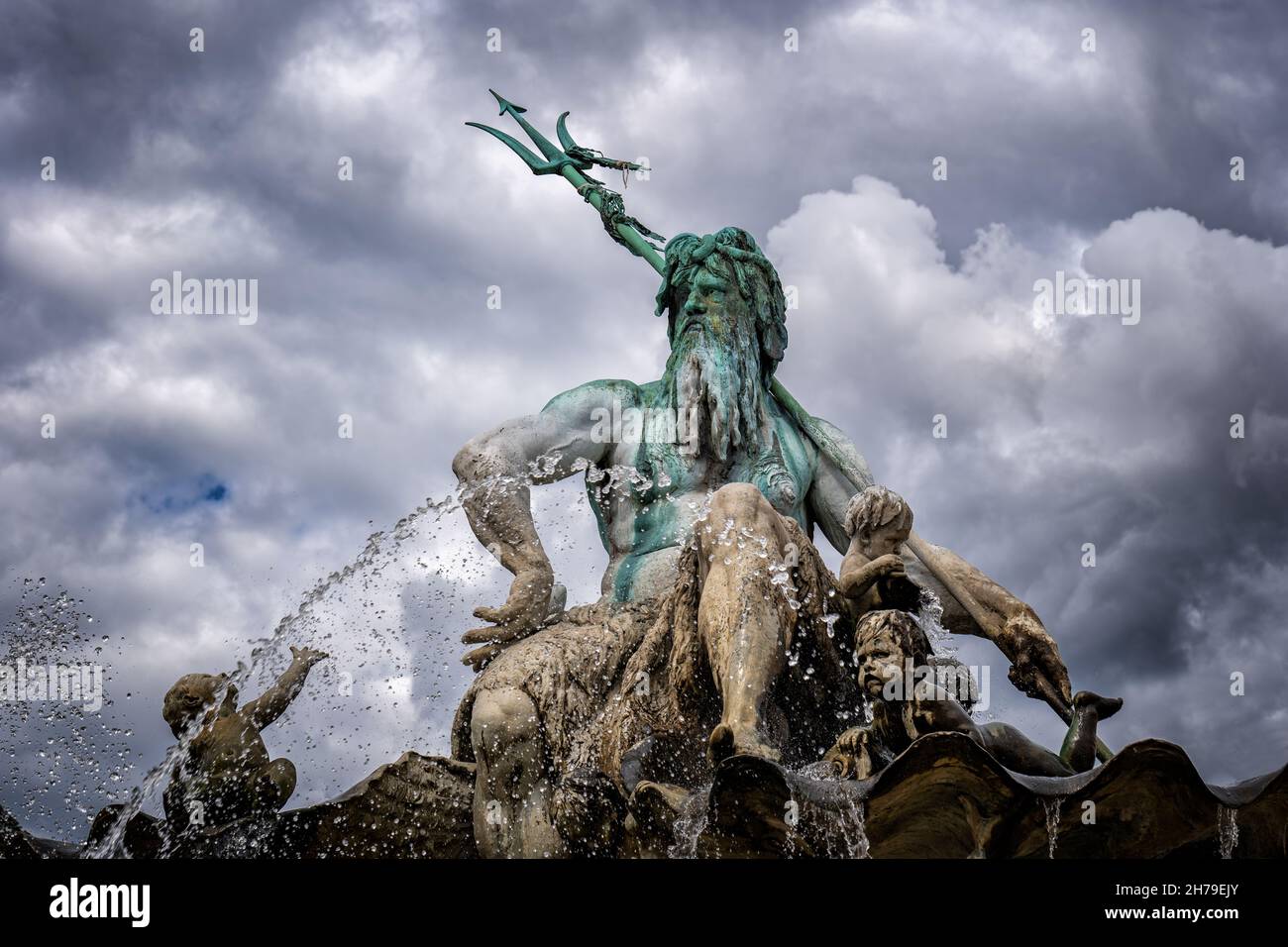 The Neptune Fountain Against Cloudy Sky In Berlin Germany