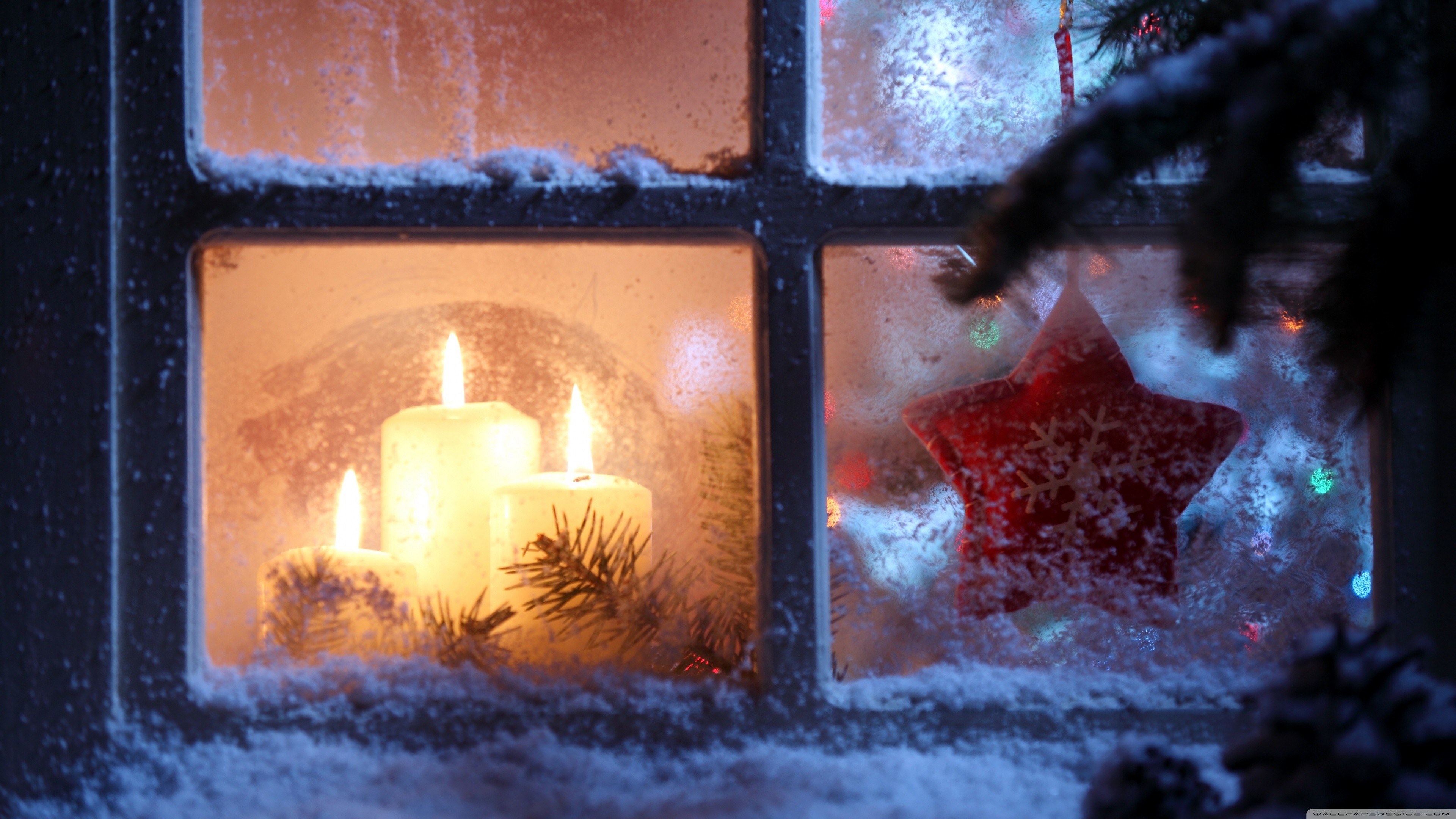 Cozy Christmas Scene: Candles and Star through a Frosty Window