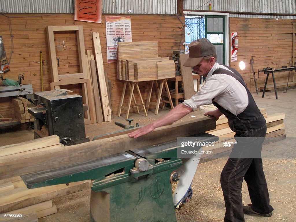 A Mennonite Carpenter Cuts Wood In His Workshop Guatrach