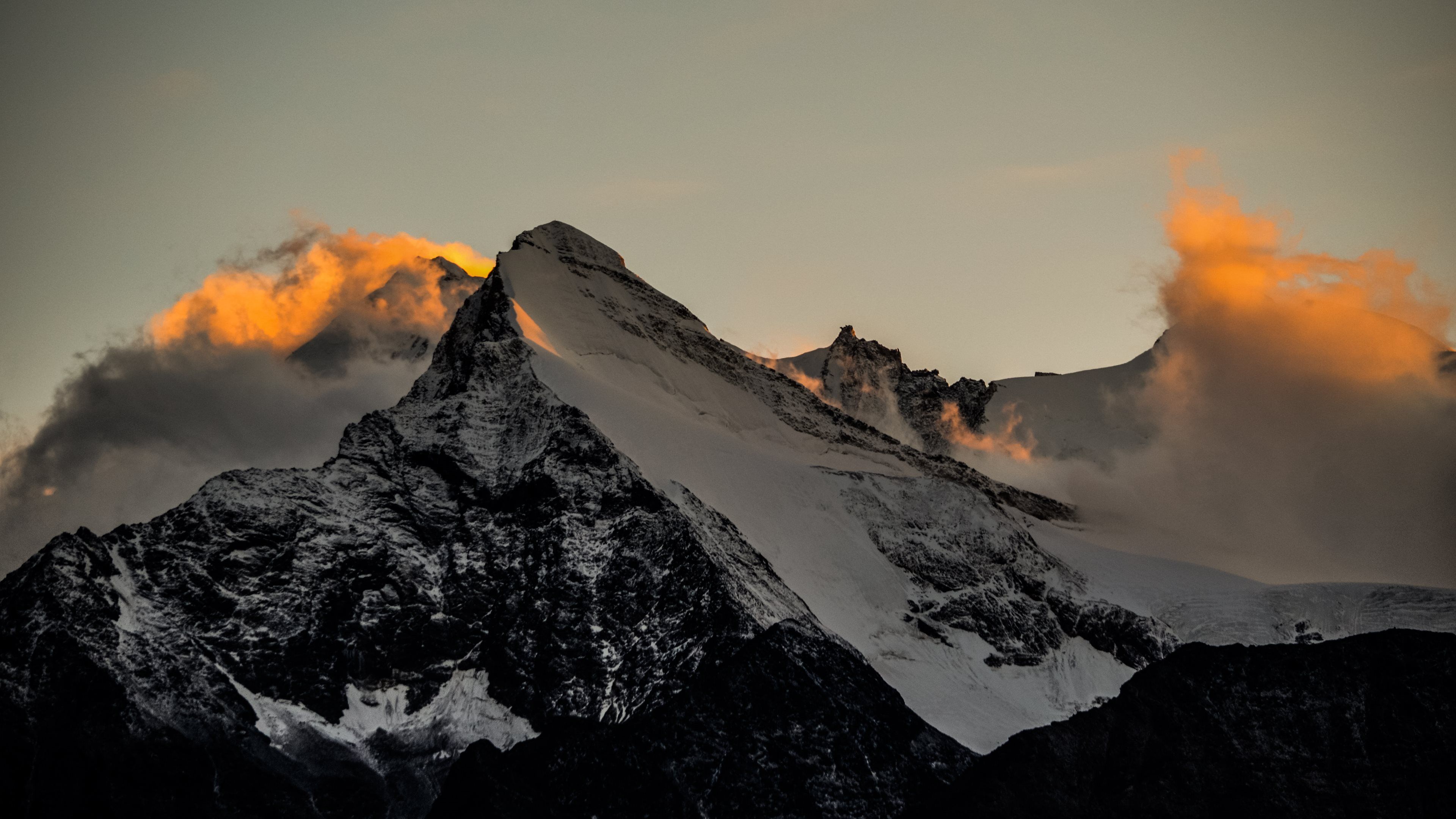 Snow-capped mountain peaks at sunset