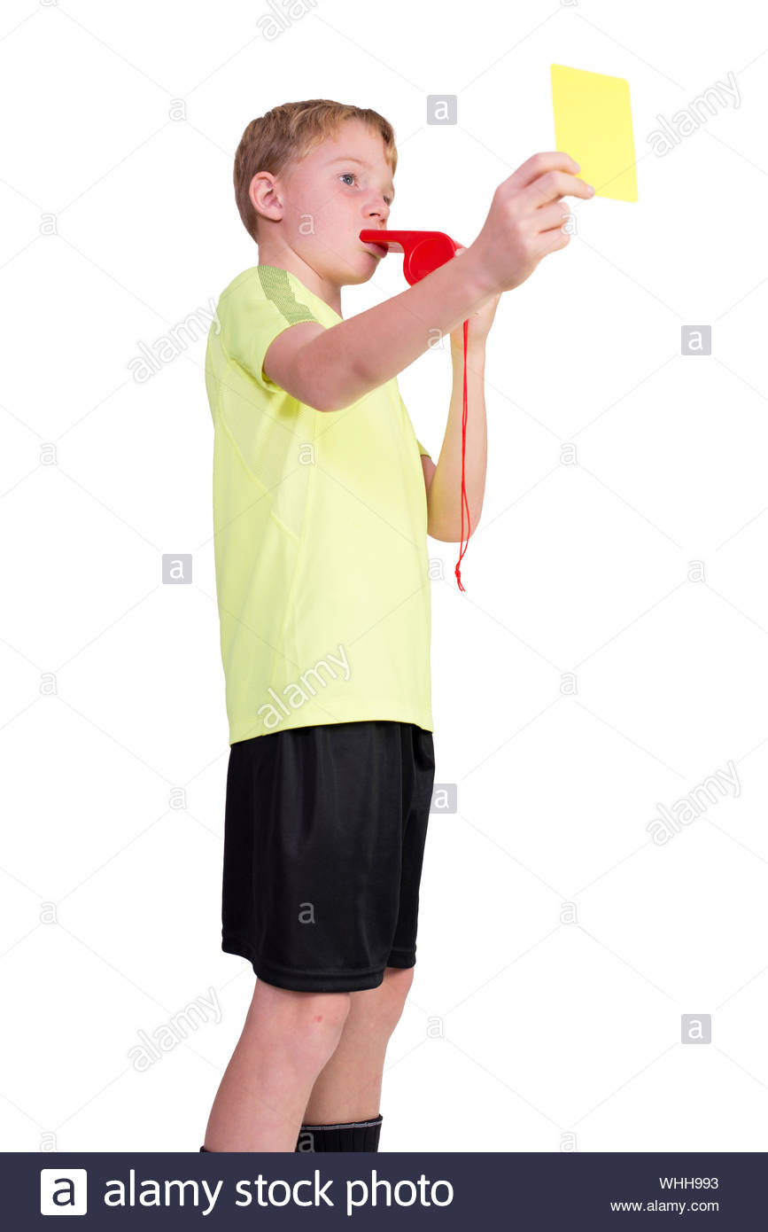 Low Angle Of Boy Whistling And Showing Yellow Card Against