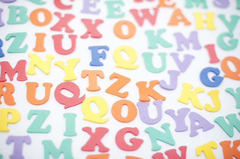 Colourful alphabet background with random scattered uppercase letters