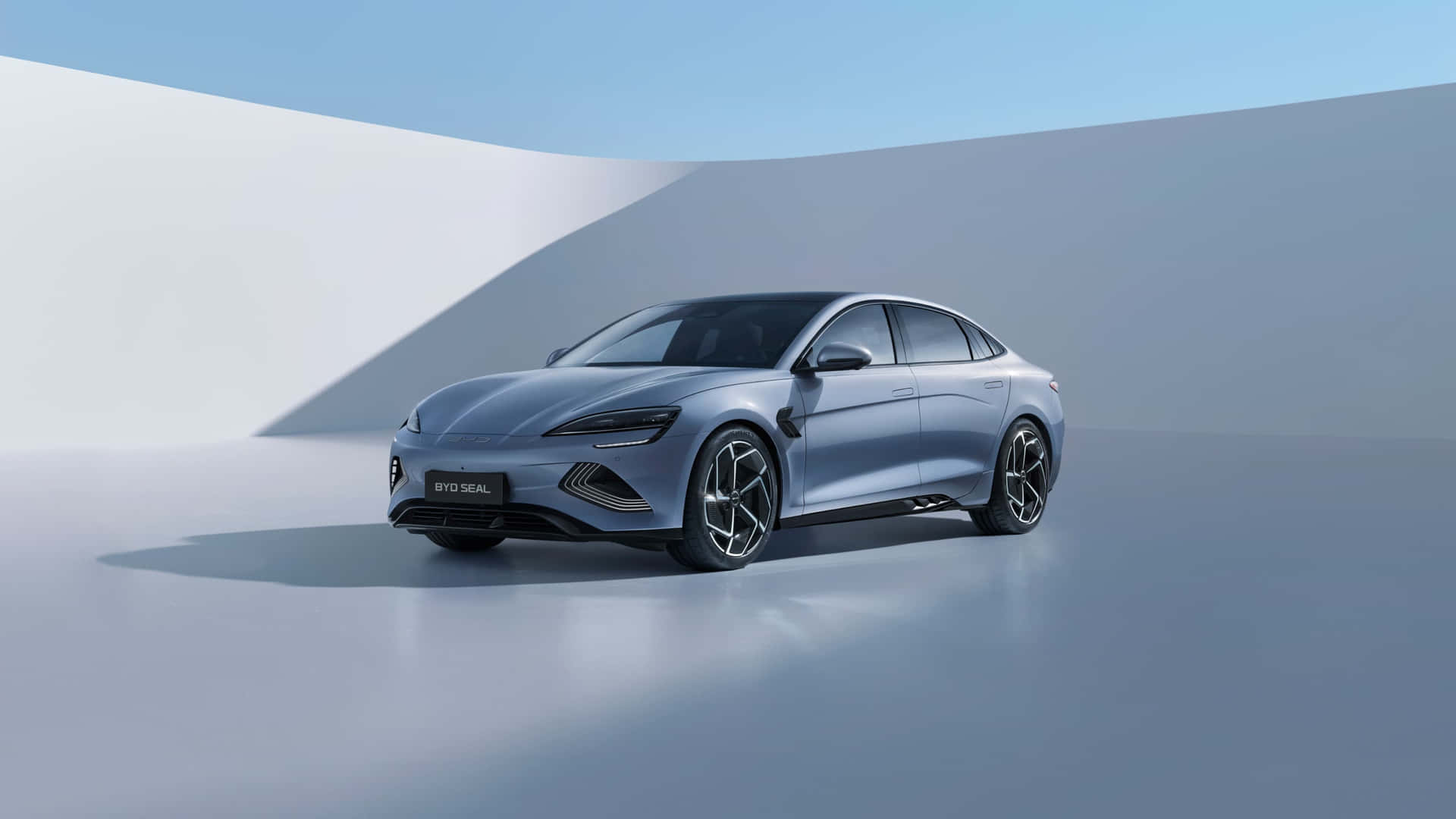 A sleek, silver BYD Seal electric sedan posed against a minimalist backdrop, highlighting its modern and aerodynamic design