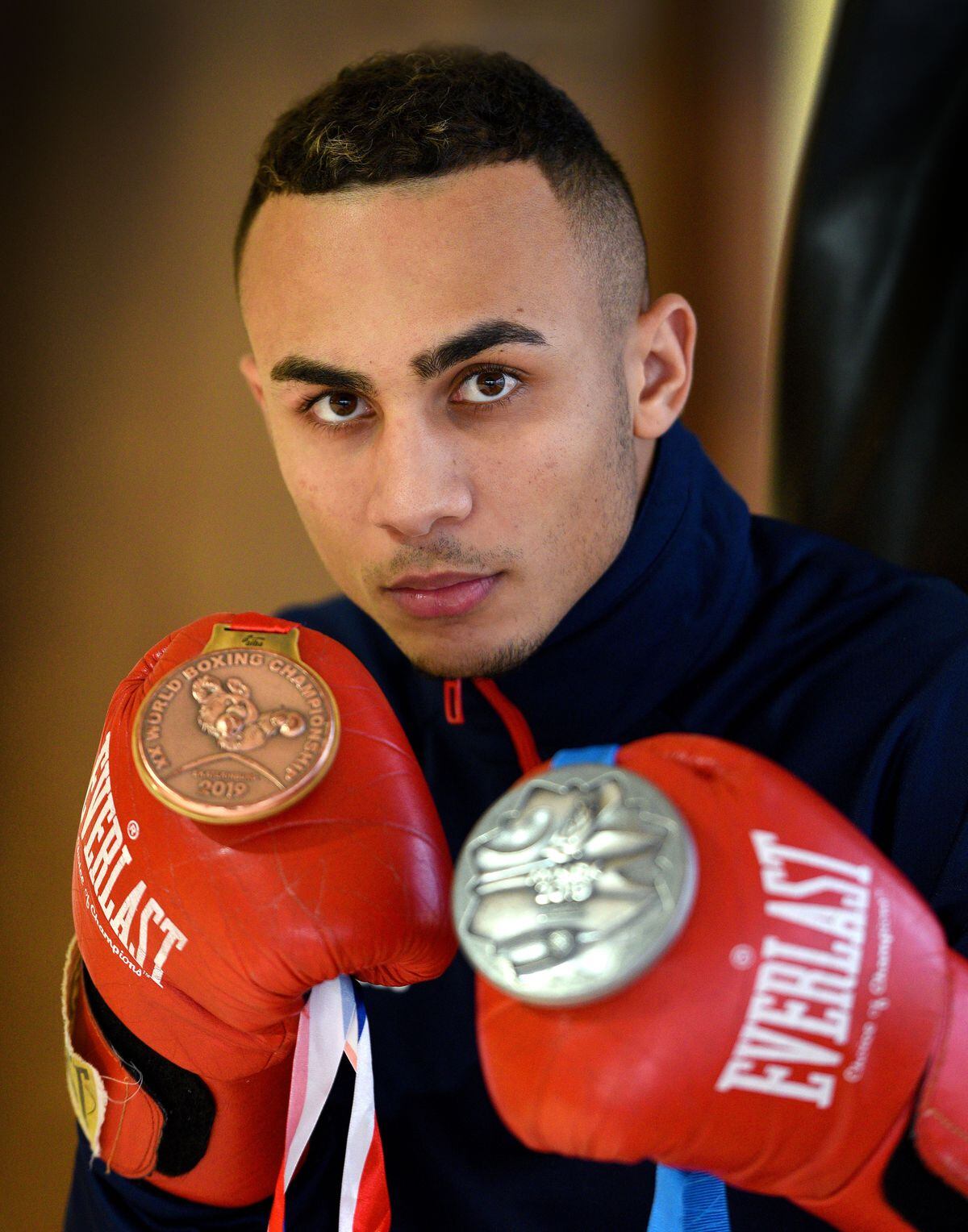 Benjamin Whittaker posing with his boxing medals