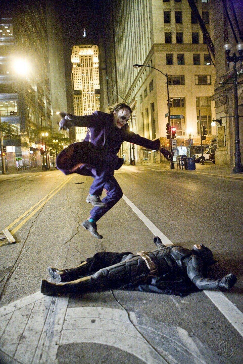 Heath Ledger As The Joker Doing A Kickflip Over Christian Bale