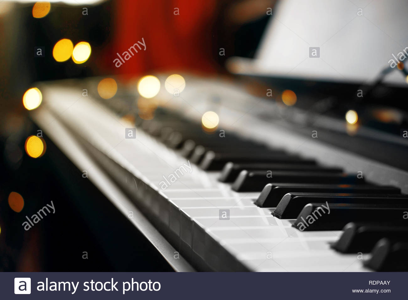 Piano Keys With Beautiful Yellow Lights Bokeh In Background