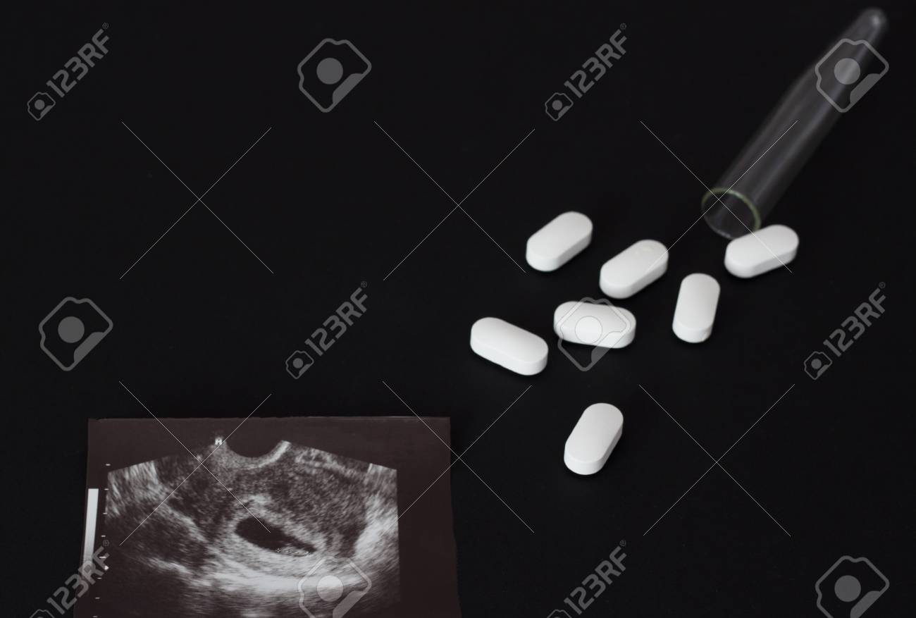 Uzi Shot Pills And Test Tube On A Black Background Abortion