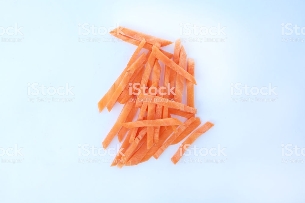 Closeup Chopped And Sliced Carrot On White Background Stock Photo
