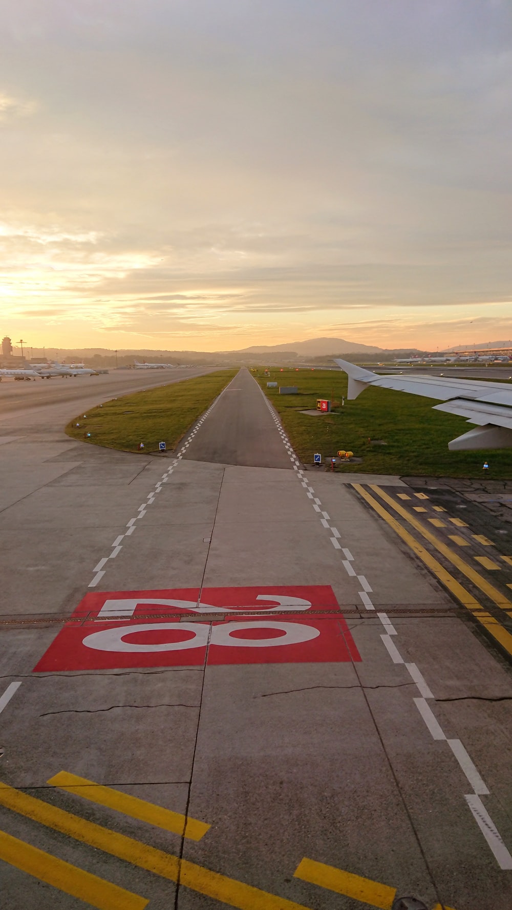 Used Concrete Asphalt Airport Empty Runway With Many Braking Marks Markings  For Landings And All Navigation Lights On Clear For Comercial Airplane  Landing Or Taking Off In Wroclaw Airport Stock Photo 