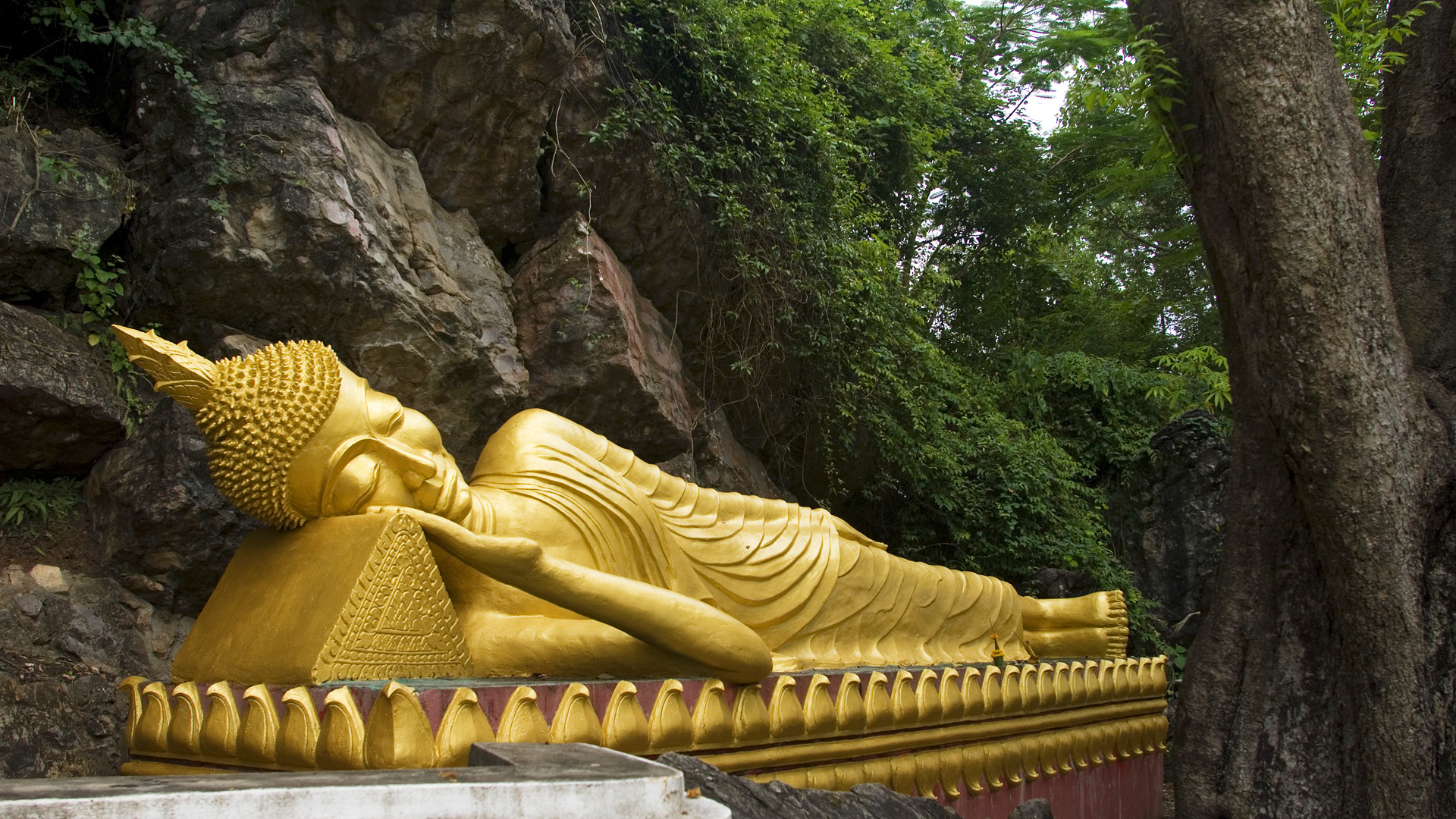 Golden Reclining Buddha Statue in a Cave