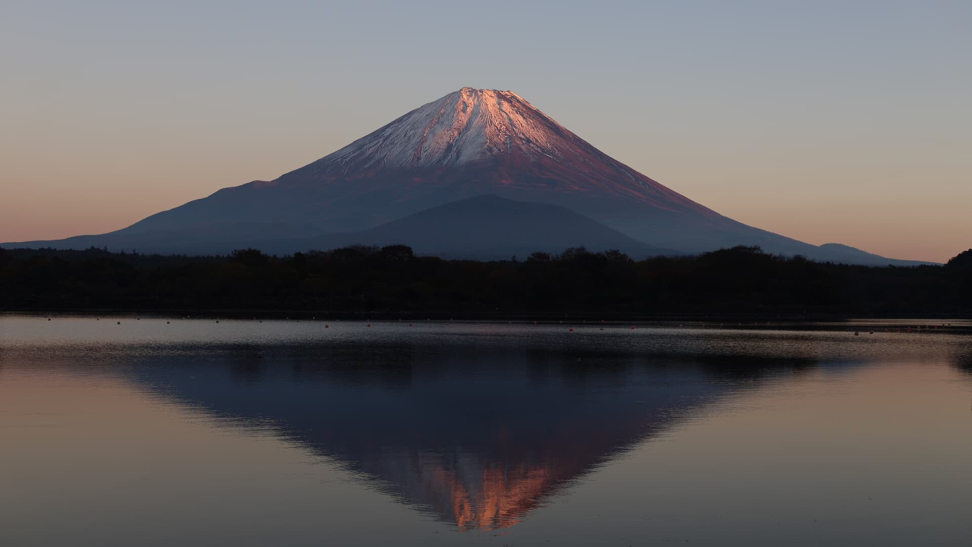 Mount Fuji reflected in a lake at sunset