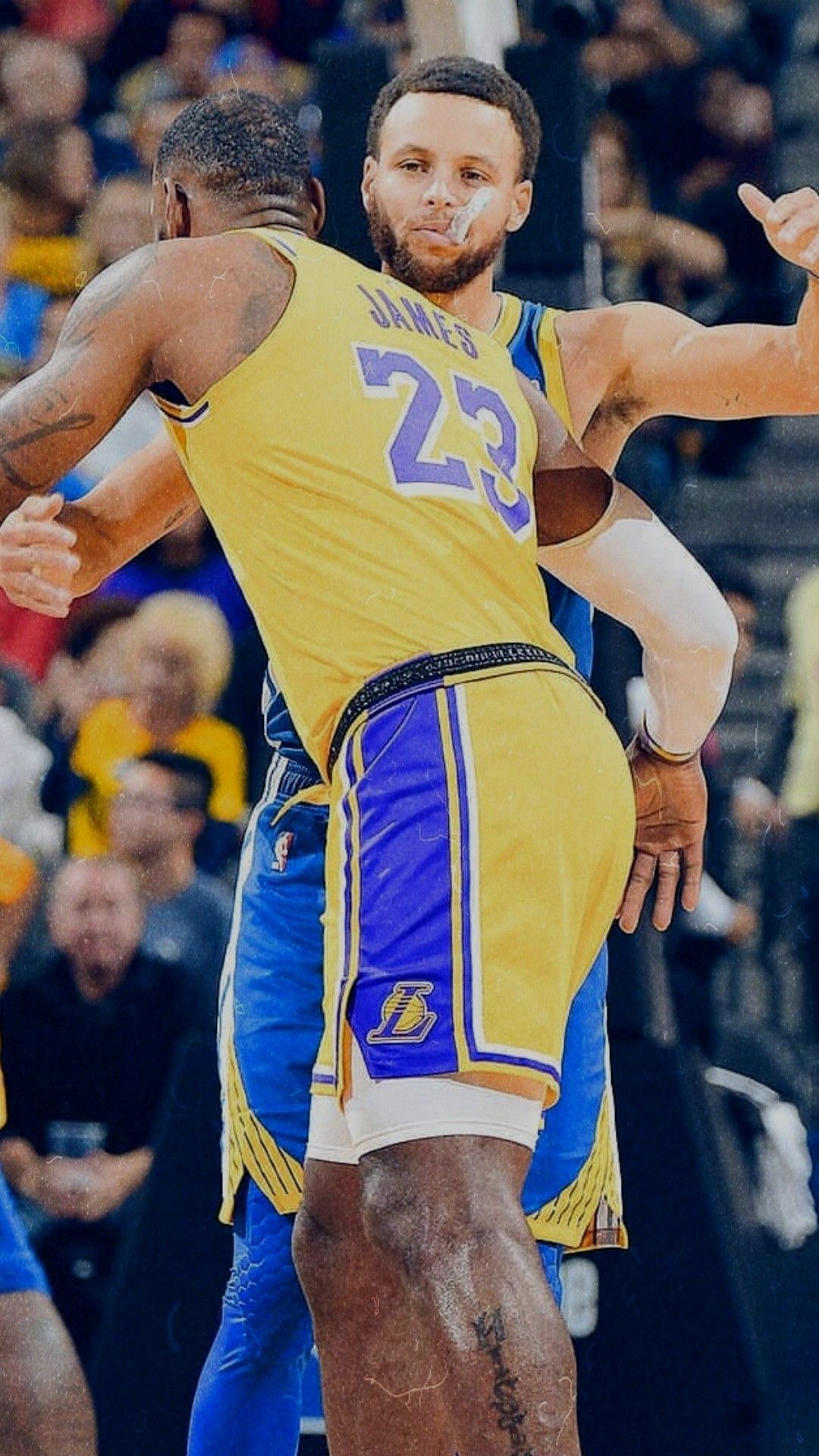 LeBron James and Stephen Curry embrace during an NBA game, showcasing their sportsmanship and camaraderie