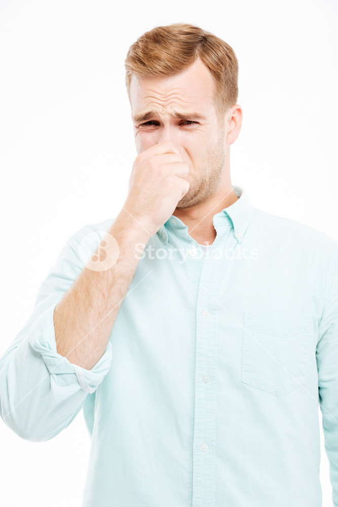 Sad Unhappy Young Businessman Closed His Nose By Hand And Feeling