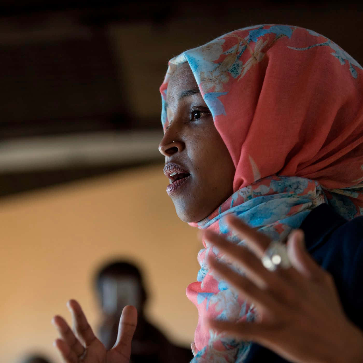 Ilhan Omar Praying With Open Arms Wallpaper