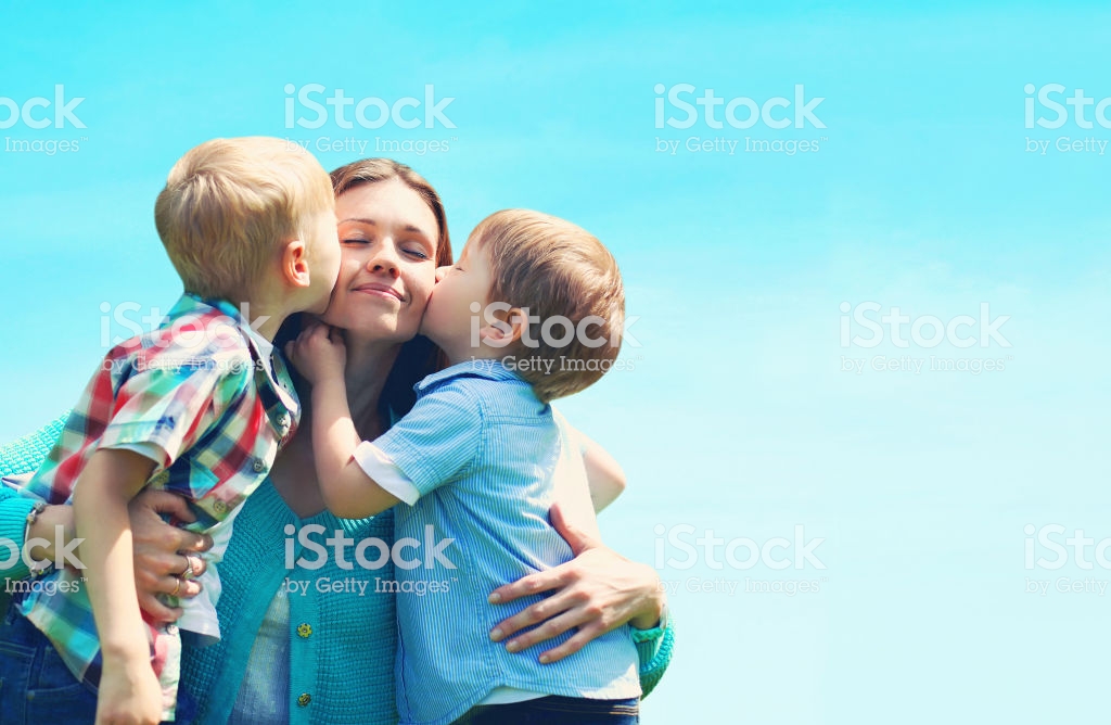 Portrait Family Two Children Sons Kissing Mom Mothers Day Blue Sky