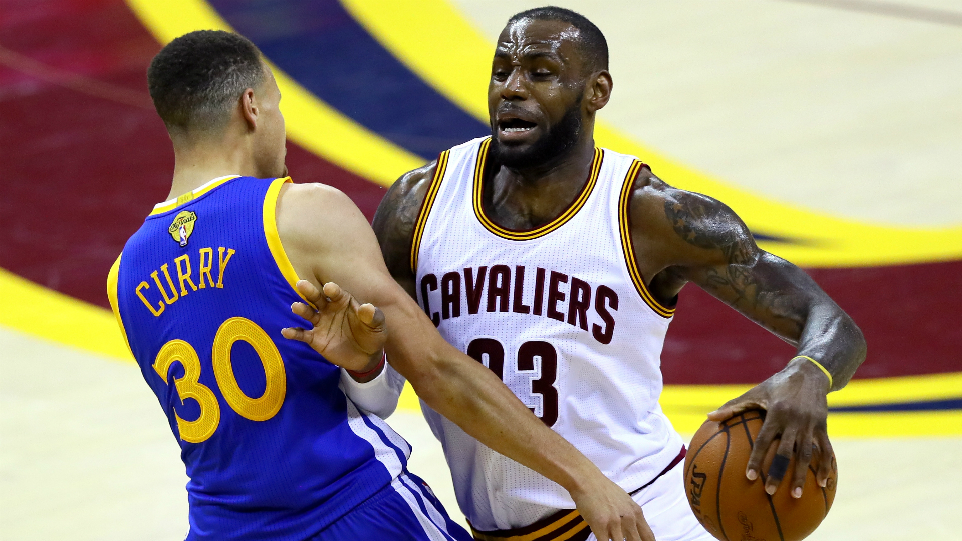 LeBron James of the Cleveland Cavaliers dribbles the ball against Stephen Curry of the Golden State Warriors during the 2015 NBA Finals