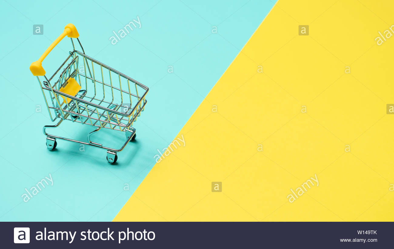 Empty Miniature Shopping Cart On Blue And Yellow Background Toy
