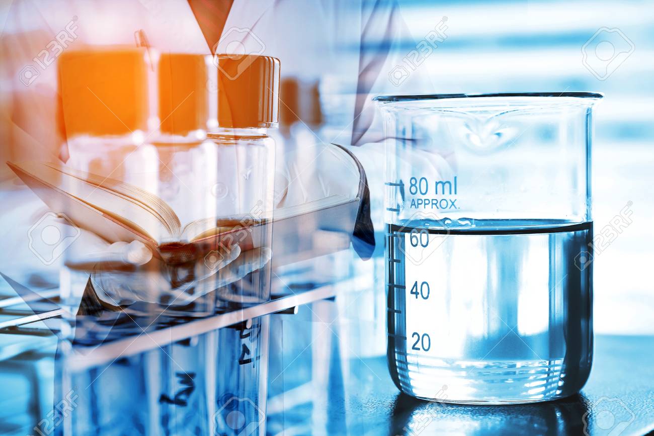 Laboratory Glassware With Scientist Background Stock Photo