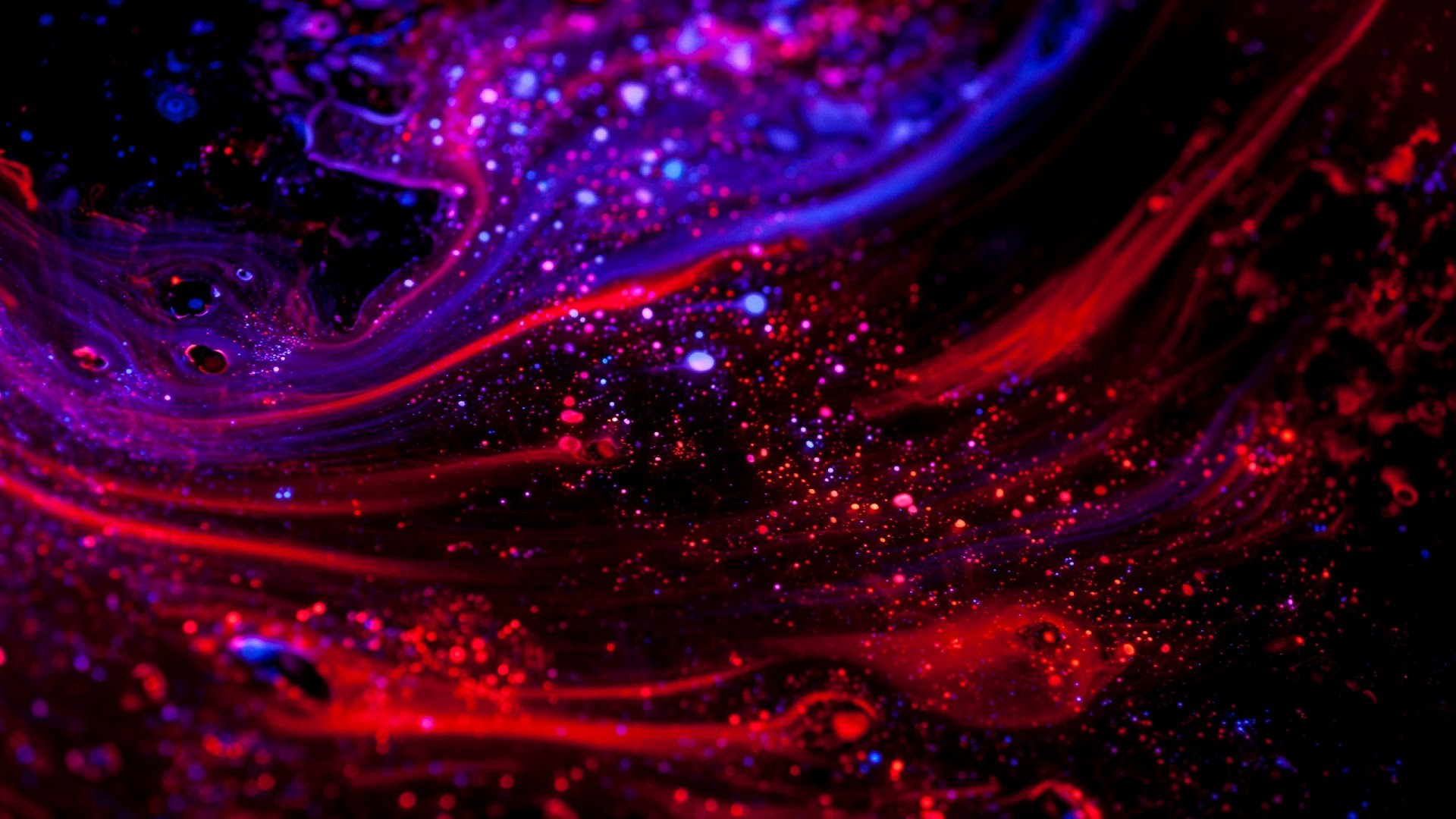 Abstract red and blue nebula wallpaper with glittering particles, perfect for a 1920x1080 screen
