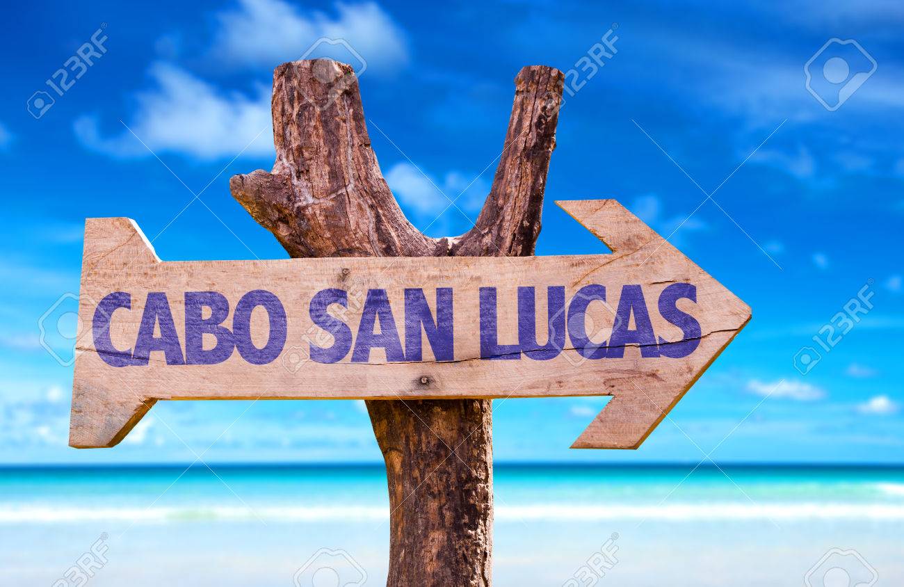 Cabo San Lucas Sign With Arrow On Beach Background Stock Photo