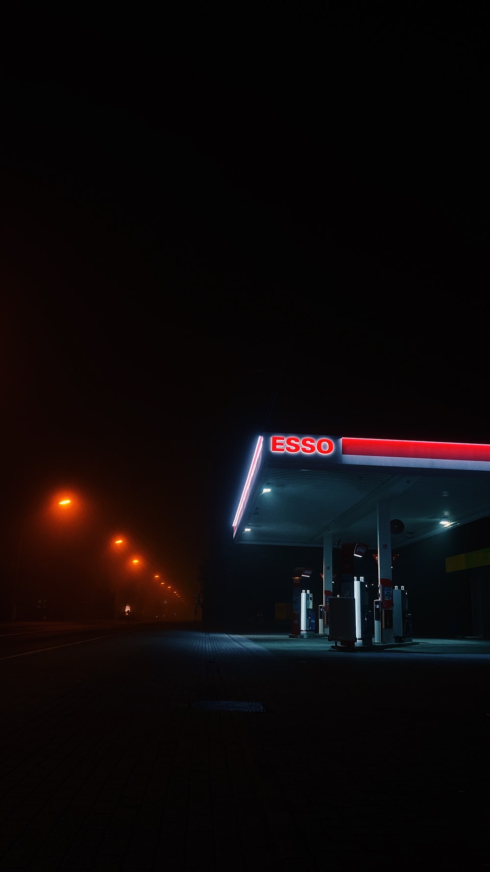 White And Blue Gas Station At Night Photo Image
