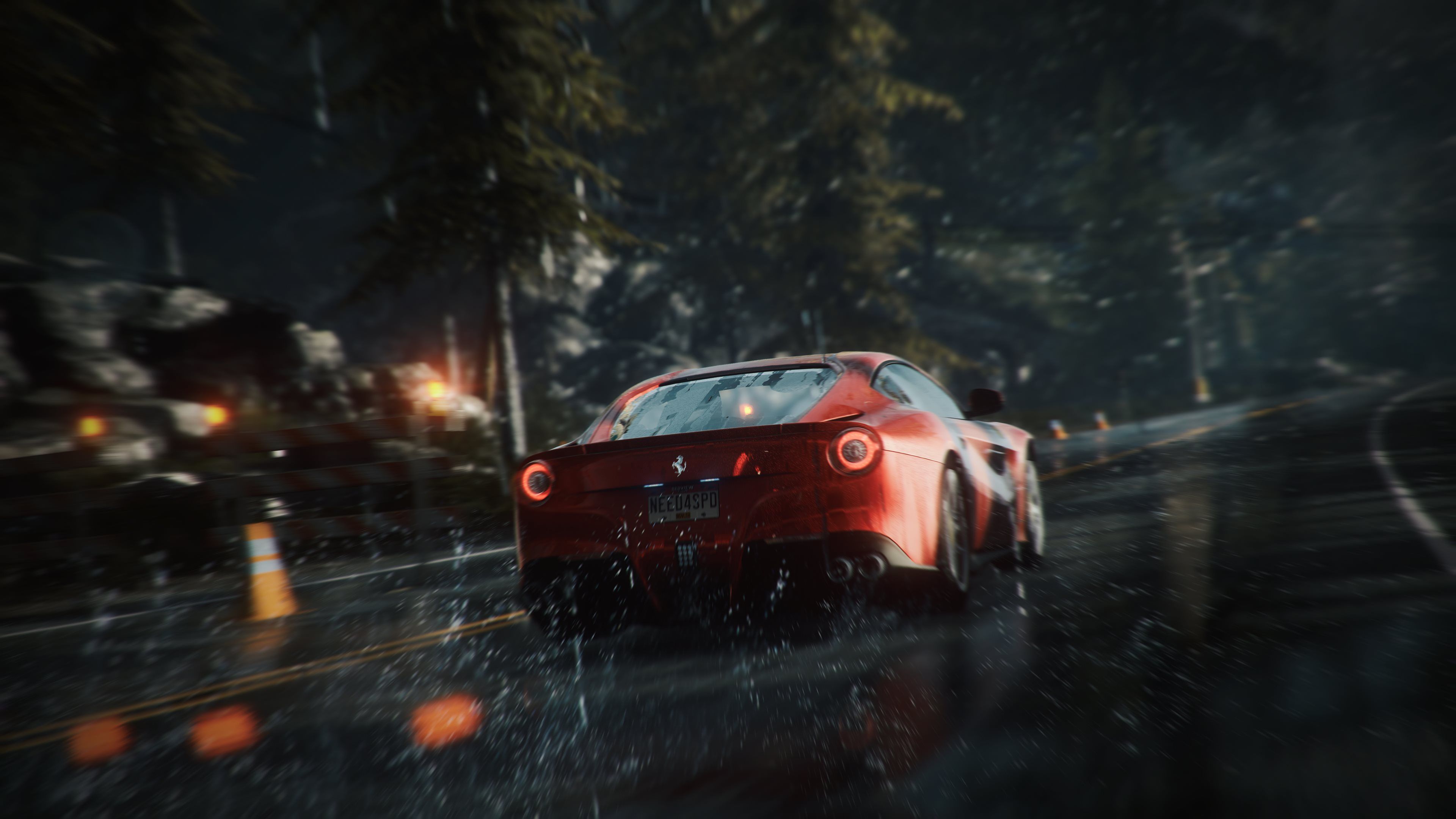 Red Ferrari sports car driving on a wet road at night in the forest