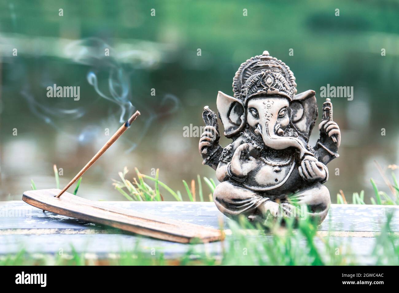 Sculpture Of Ganesha God With Aroma Stick In The Background